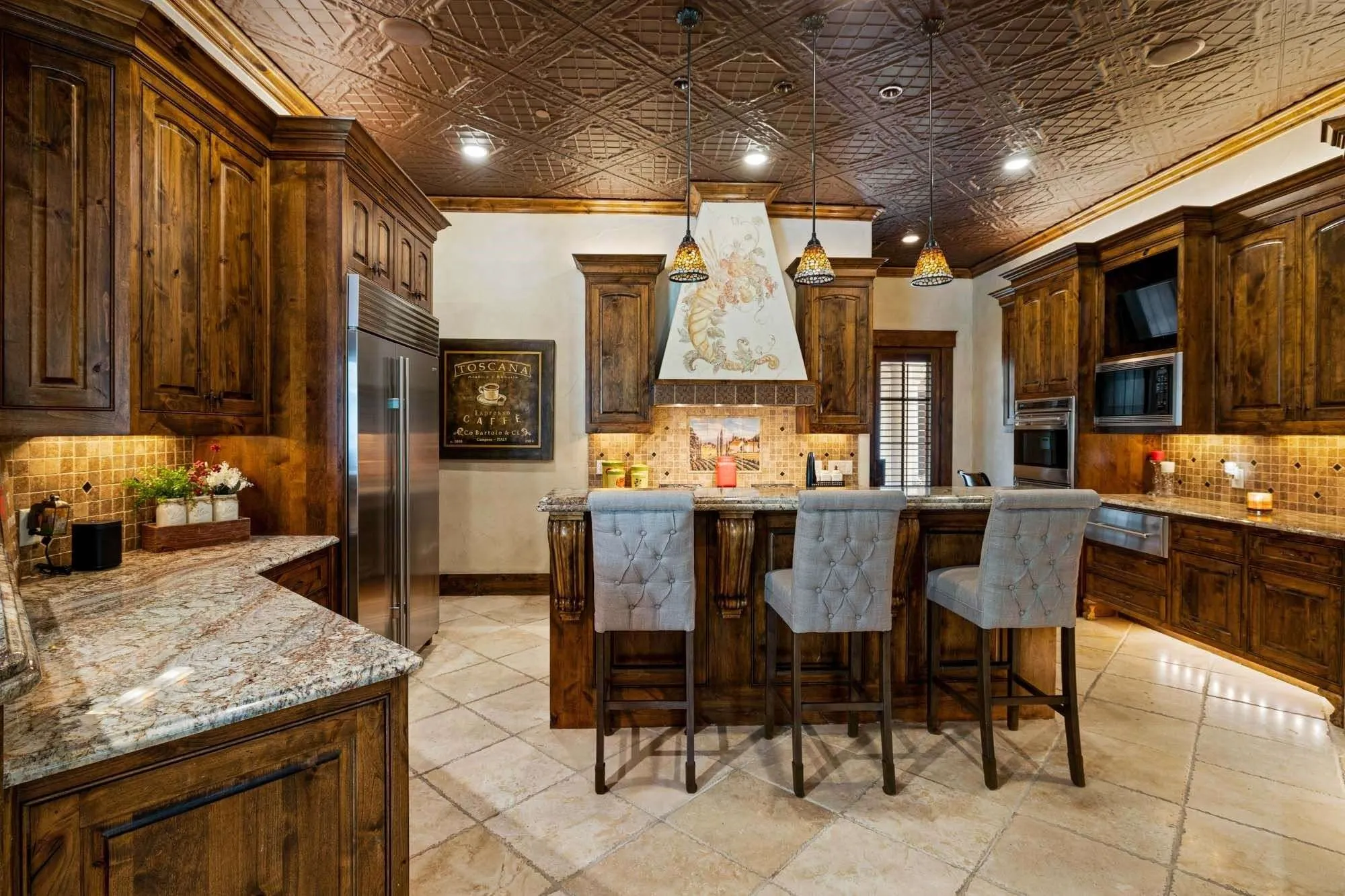 Kitchen with built in fridge, gas cooktop, multiple ovens, warming drawer, and huge pantry