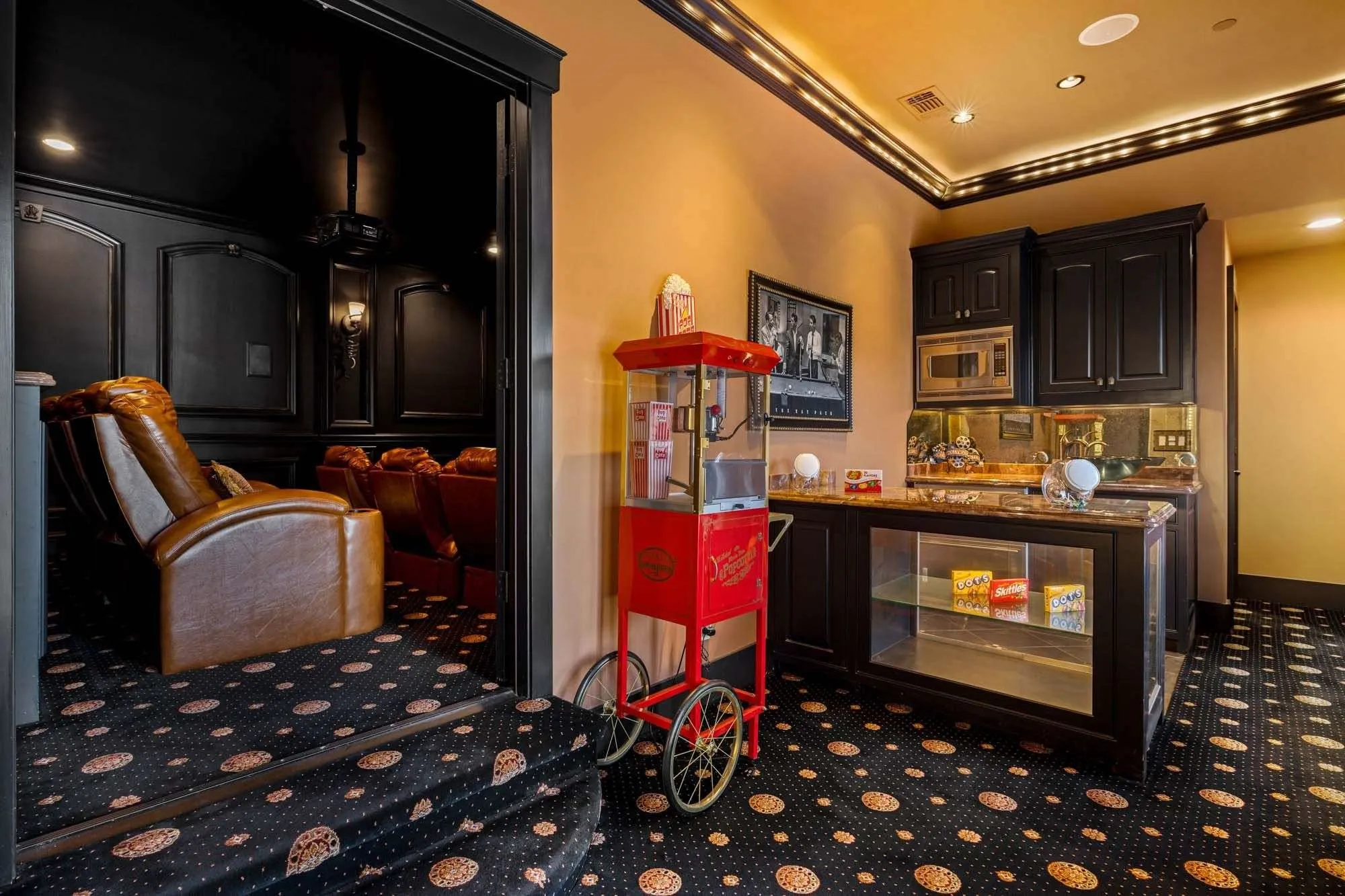 Cinema quality media room with sink, microwave, and fridge