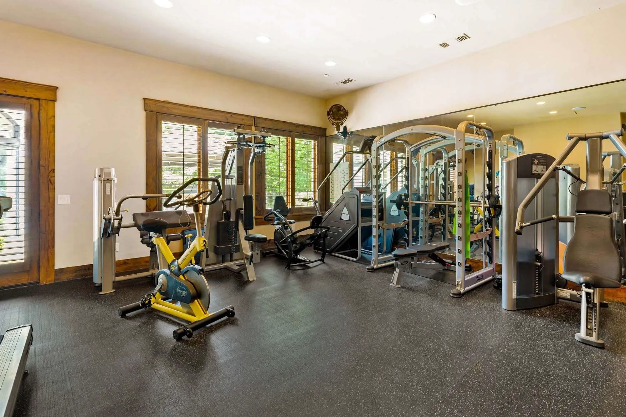 Massive gym overlooking pool with access to full bathroom
