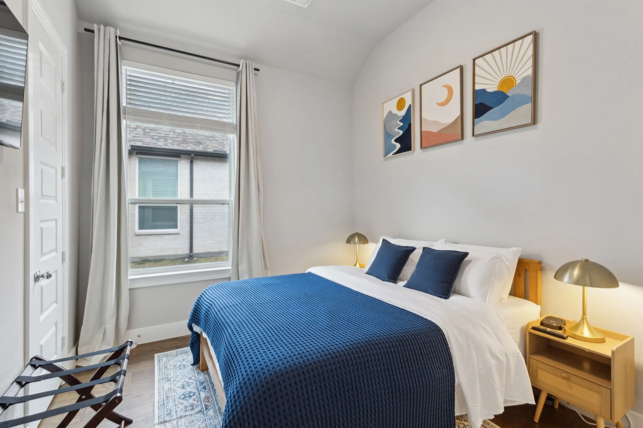 Recessed lighting, wood-finish flooring, and a large window with blinds