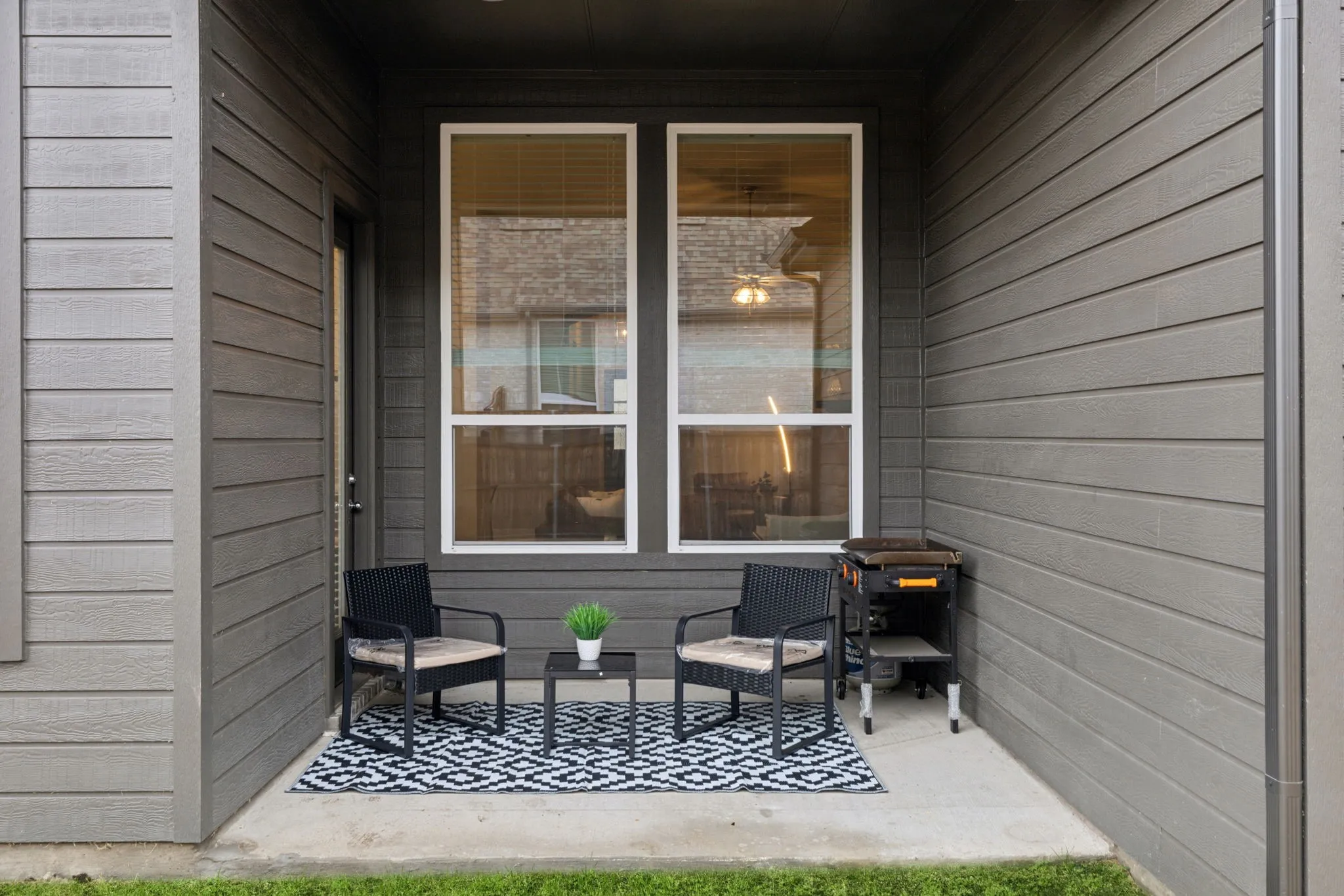 Private concrete patio with horizontal siding and exterior door