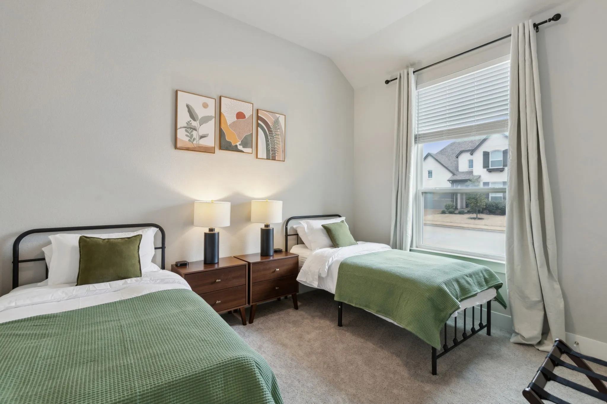 Textured wall finish, vaulted ceiling, large window with blinds, and carpeted flooring