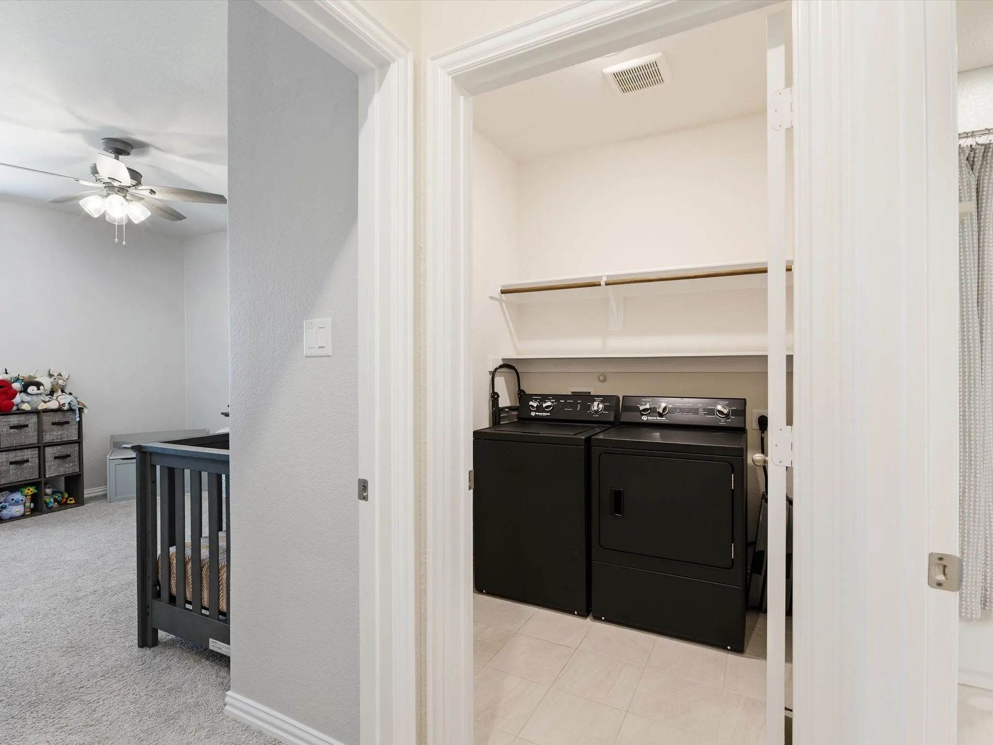 Laundry area featuring shelving and tile flooring
