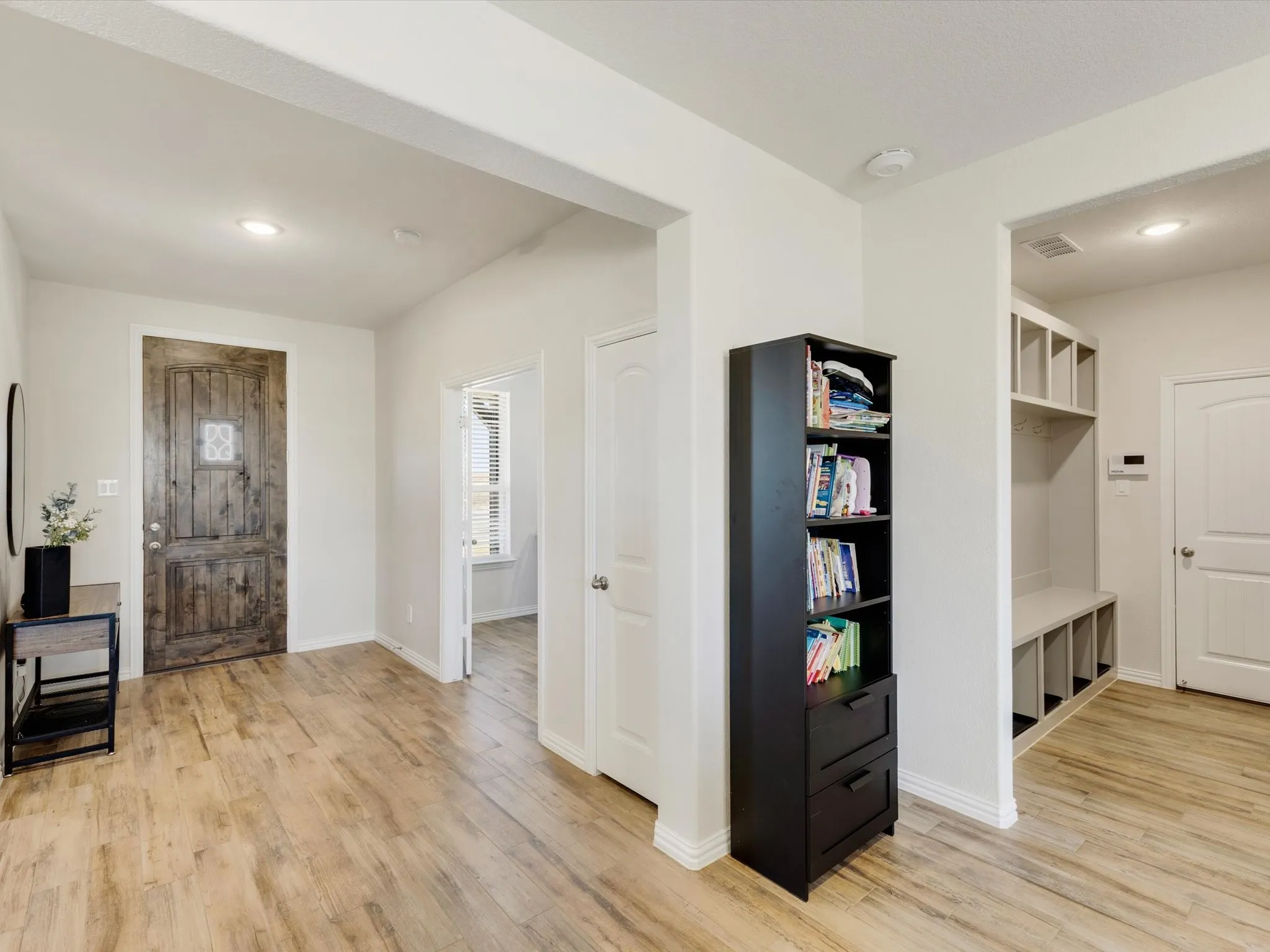 Foyer featuring a rustic wood entry door with glass inlay, recessed lighting, and wood-finish flooring