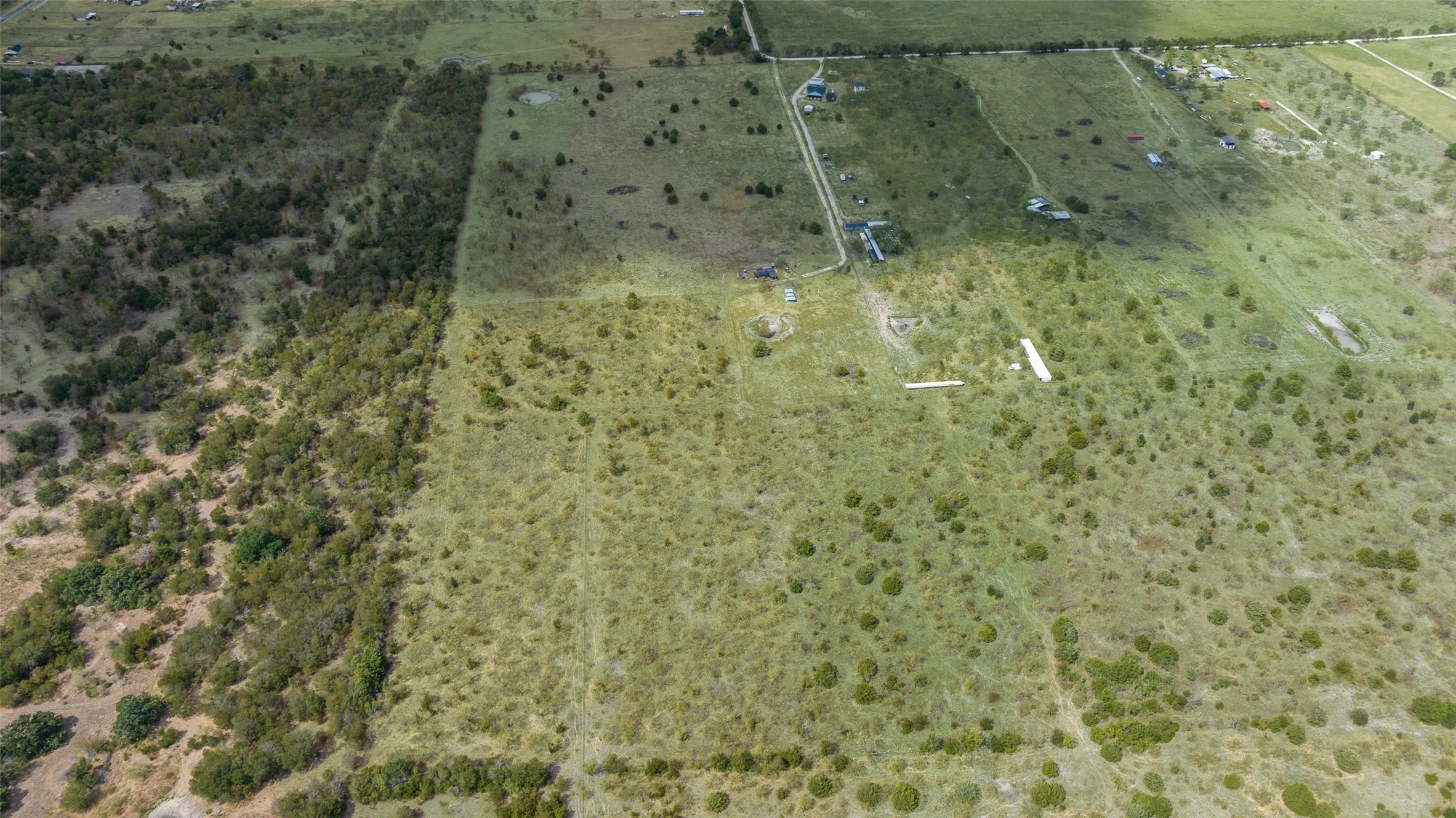 Expansive green space featuring varied vegetation and clear land divisions