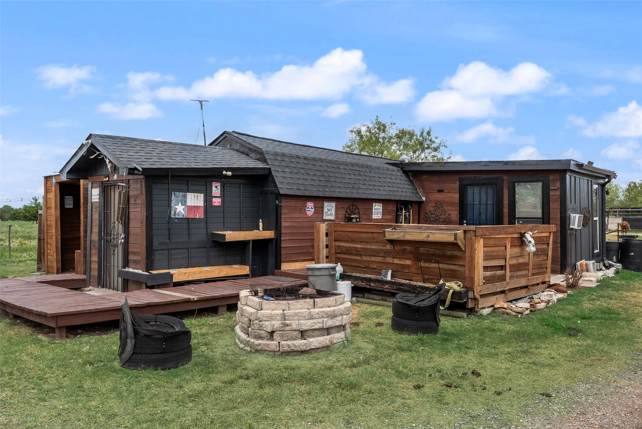 Exterior structure featuring wood siding, shingle roofing, and a built-in outdoor bar