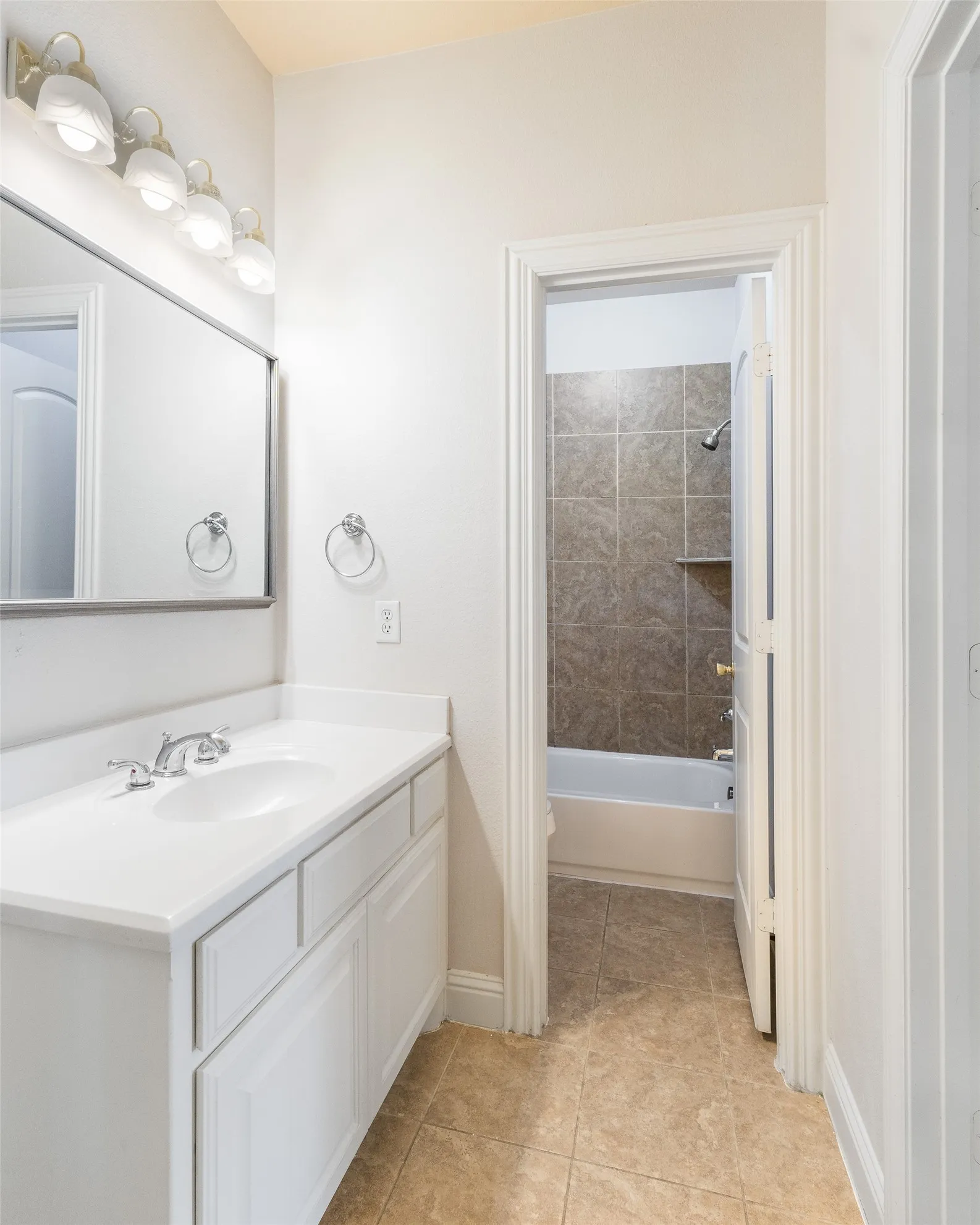 White vanity with integrated sink and chrome faucet