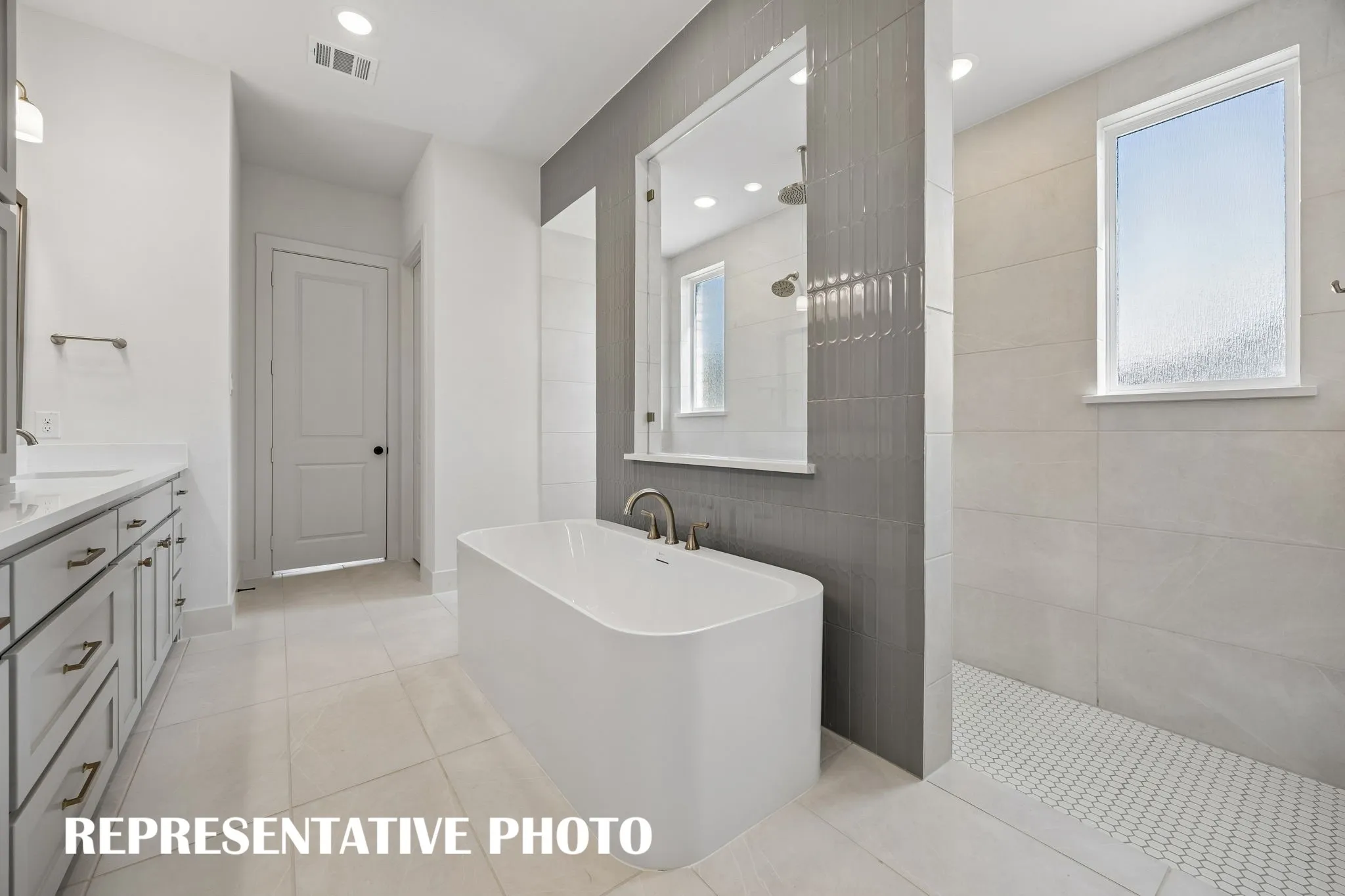 Featuring our signature walk through shower with free standing tub, you will enjoy a spa like experience every day in this wonderful owner's bath.  REPRESENTATIVE PHOTO