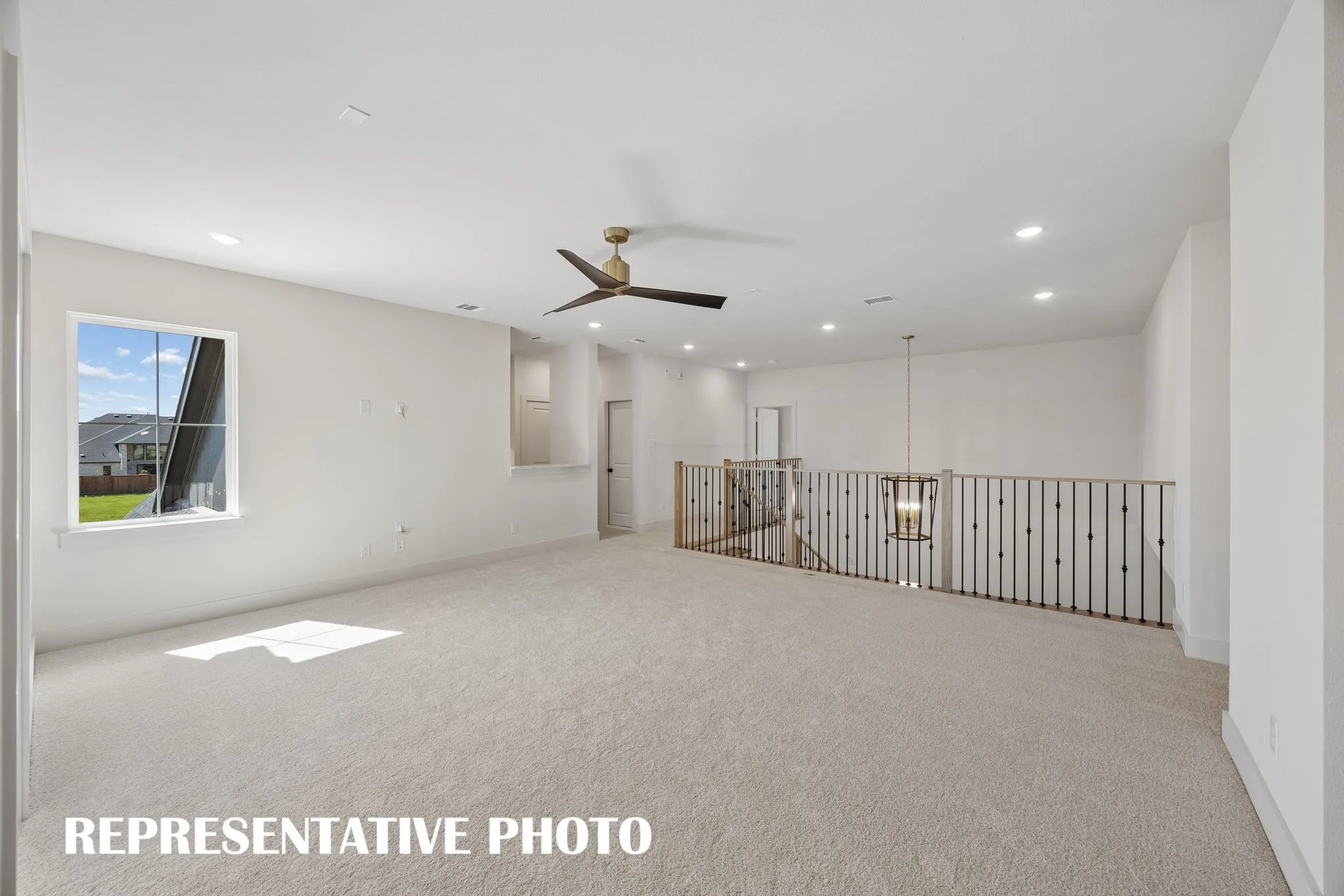 Whether hosting a big game day party or family game night, this spacious game room paired with adjacent media room creates the ultimate family entertainment zone!  REPRESENTATIVE PHOTO