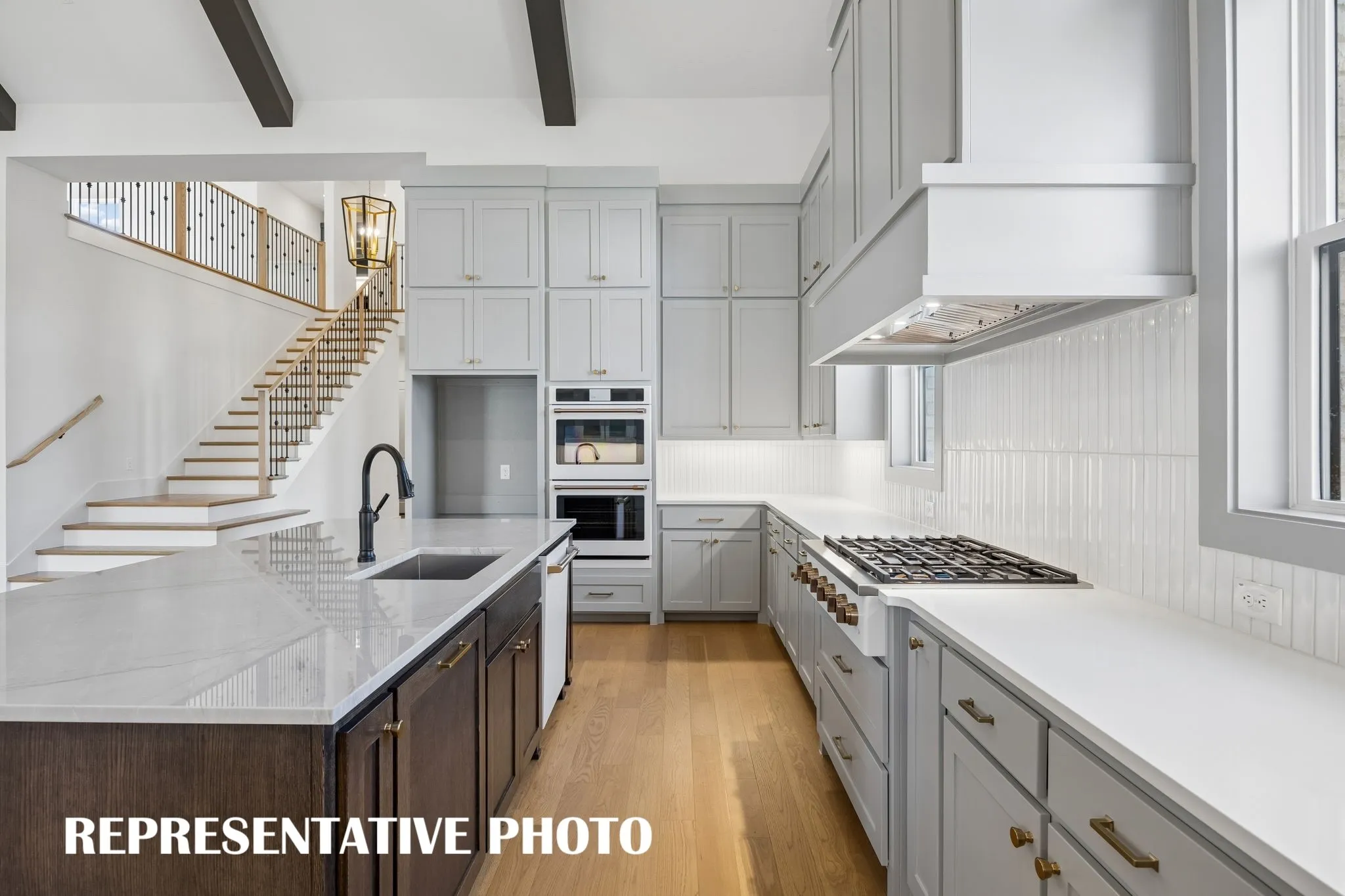 Beautiful cabinetry, gorgeous countertops and designer backsplash effortlessly pair with top of the line, contemporary appliances to create a kitchen for the ages!  REPRESENTATIVE PHOTO