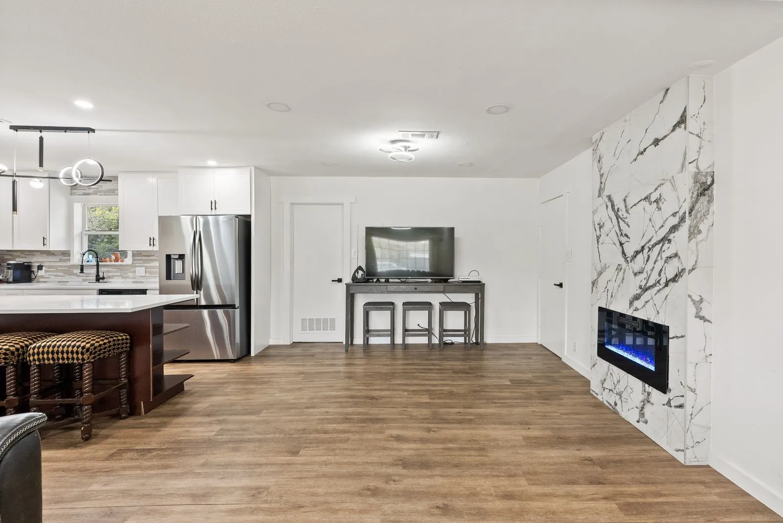 Modern kitchen with white cabinetry and stainless steel appliances