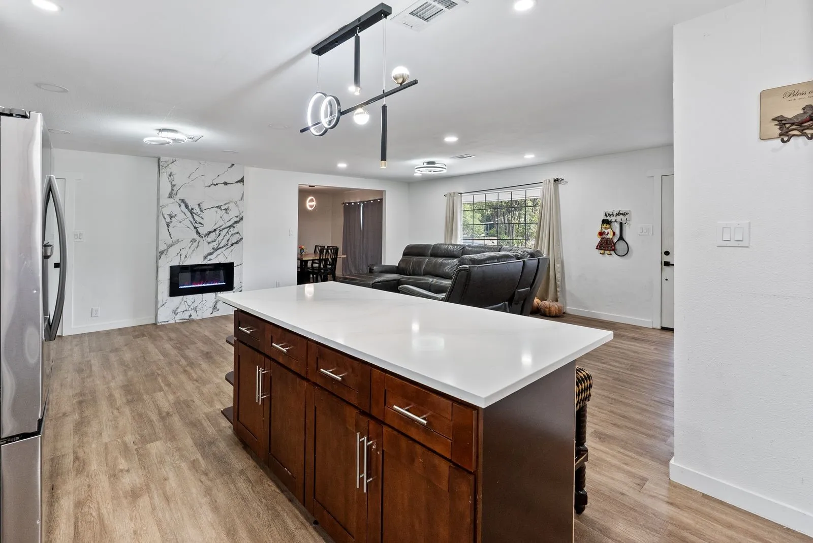 Expansive kitchen island with white countertop and wood-finish cabinetry