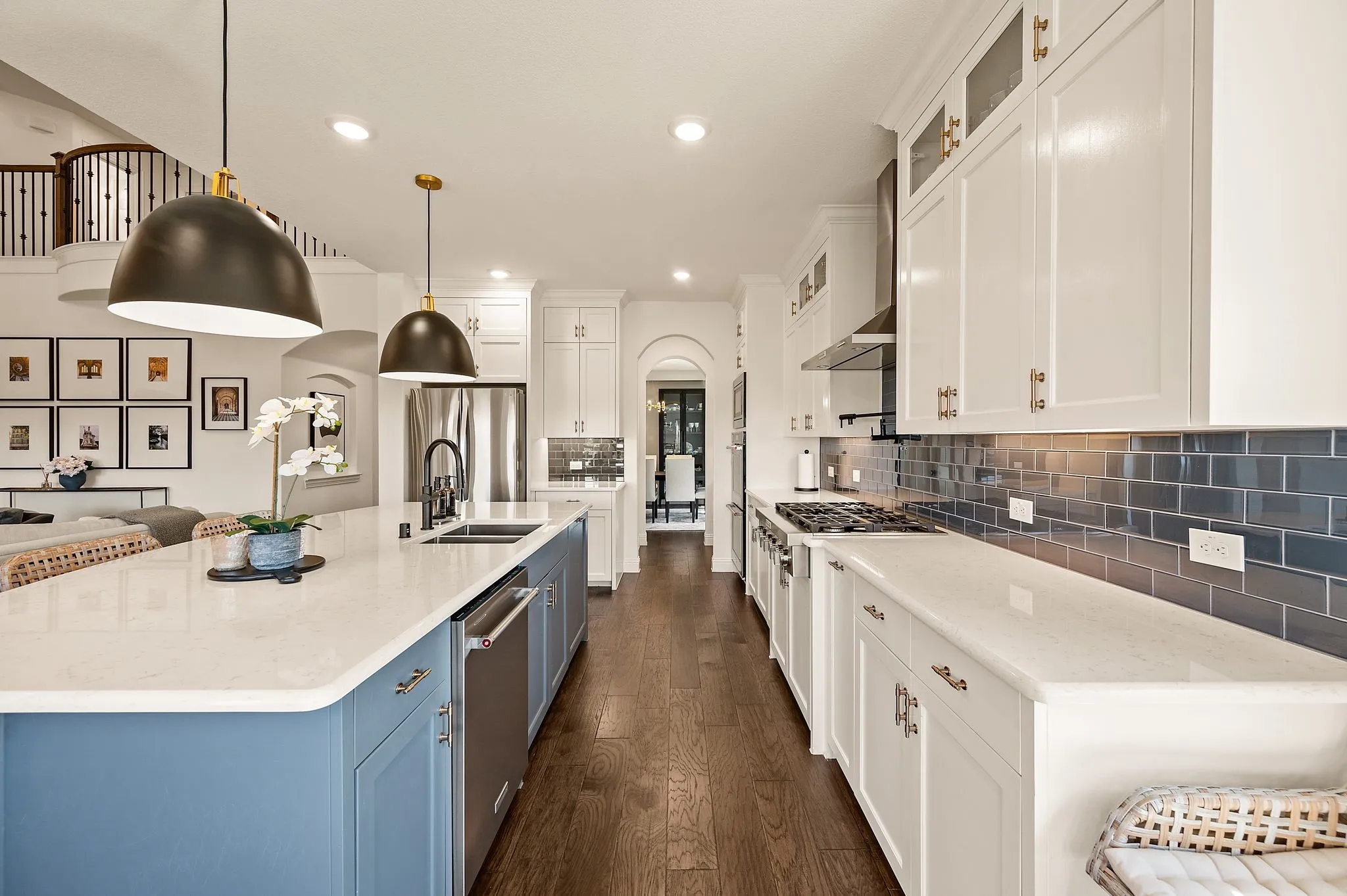 Lovely, functional kitchen features quartz surfaces, subway tile, updated pendant  lights!