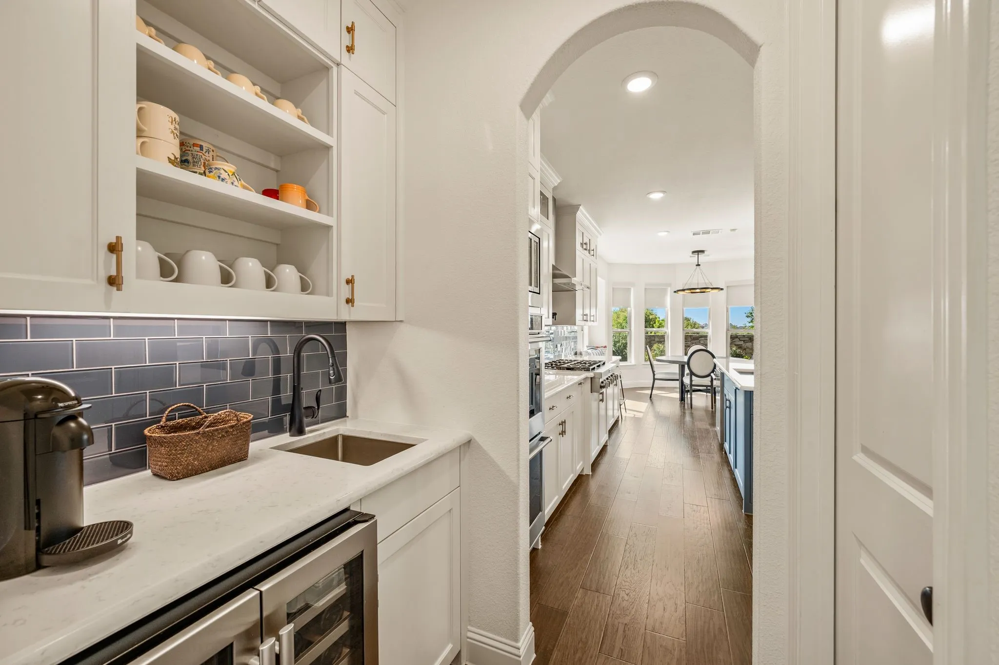 Butlery-bar with wine cooler connects formal dining to kitchen.