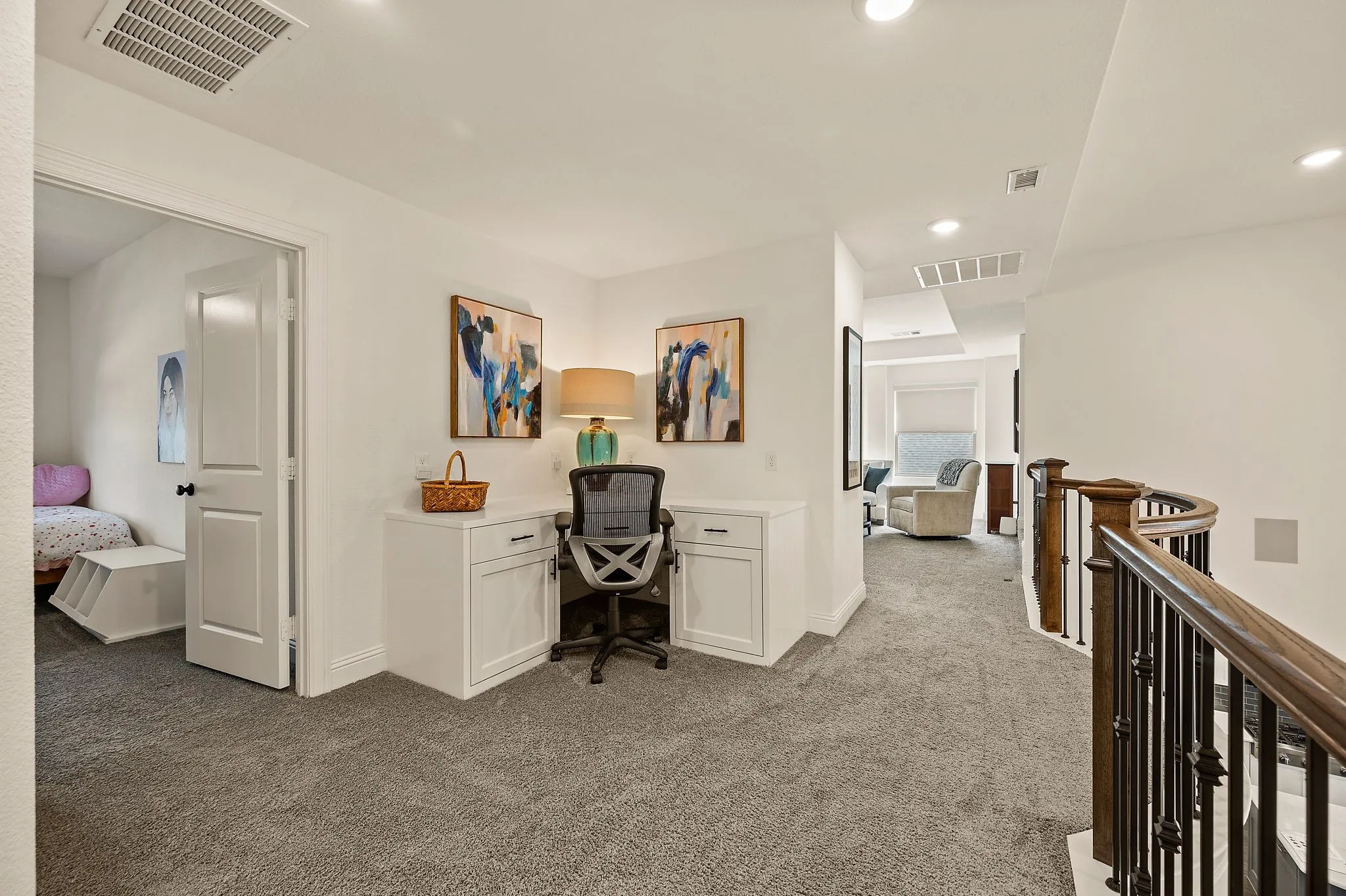 Loft area at top of stairs features a handy built-in work space.