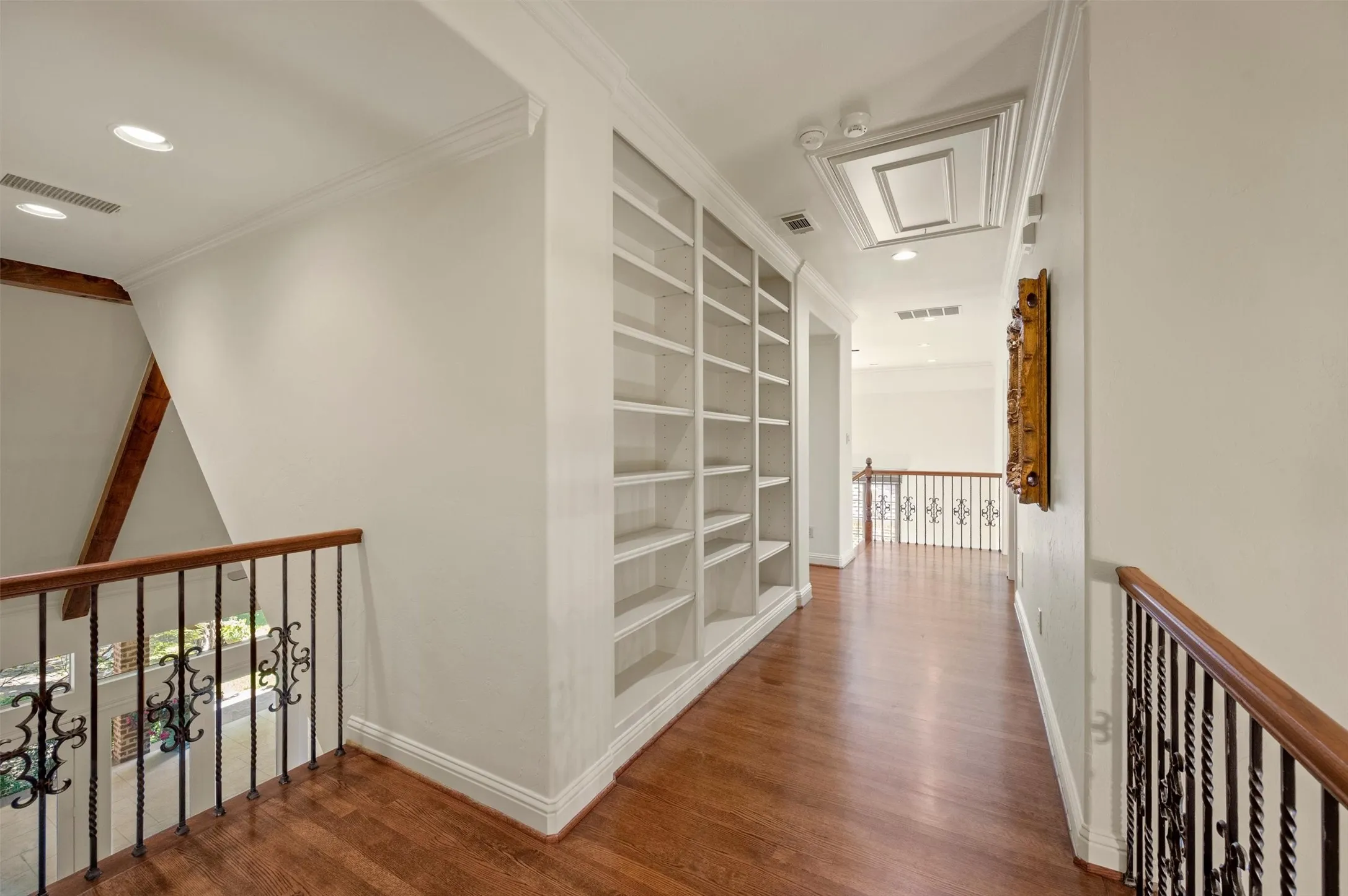 Not your typical upstairs hallway! View downstairs and storage complete the space.