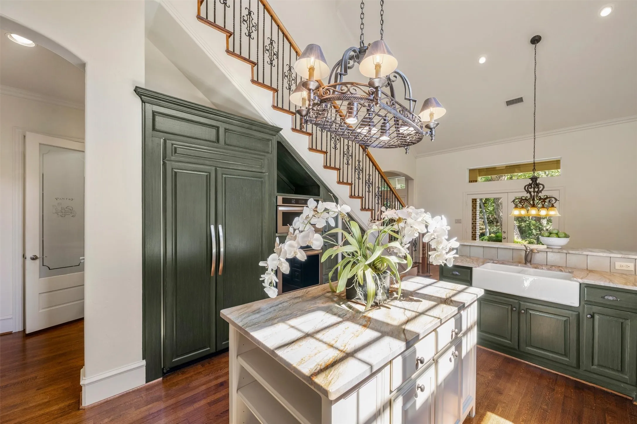 Built-in refrigerator and rare leathered granite countertop that is such a serene natural color. Must see!