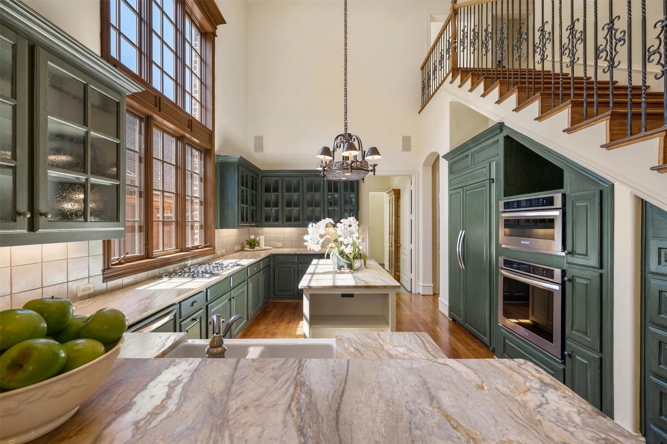 Two story windows offer a bright and cheery kitchen.