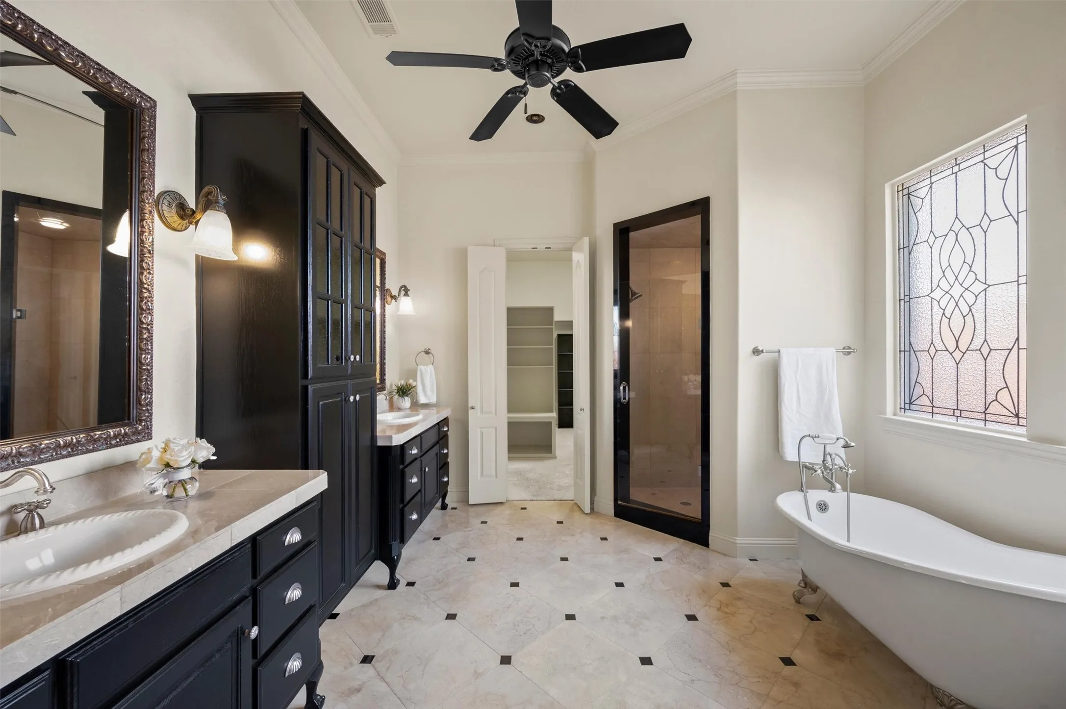 Large walk in closet, two vanity areas, separate water closet and built in storage.