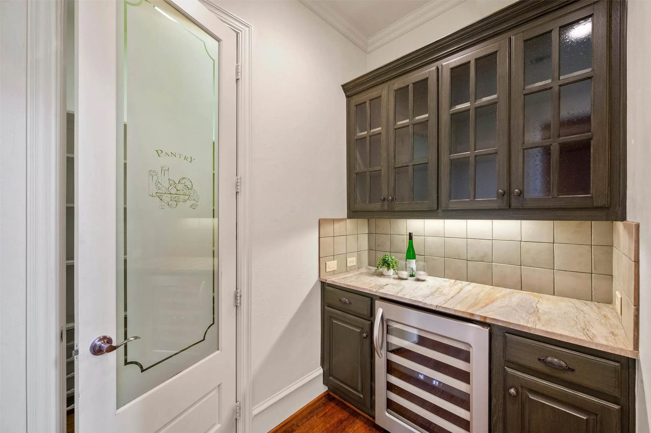 Butlers pantry with beverage refrigerator and walk in panty. Leads to formal dining room OR kitchen.