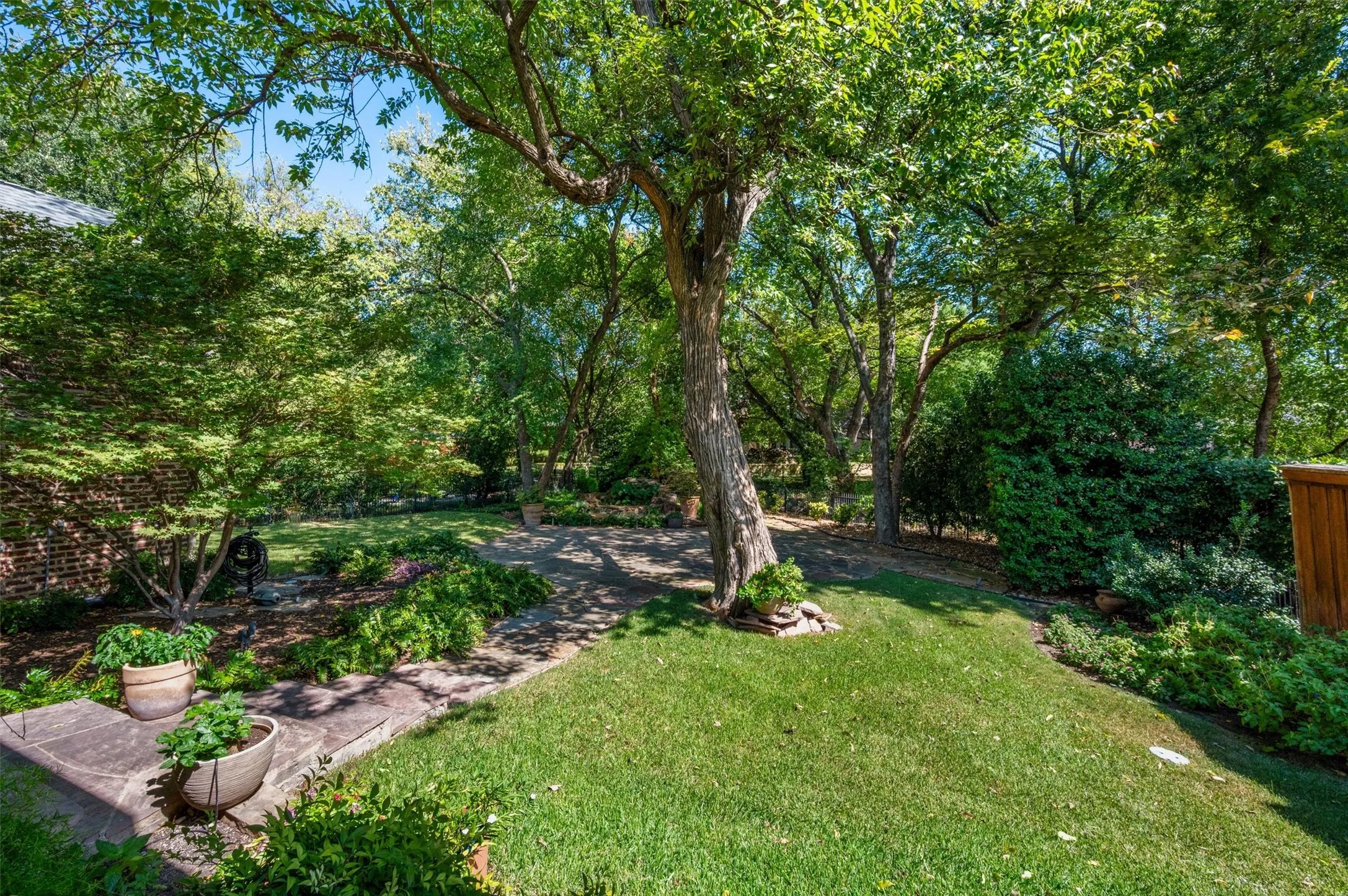 This property backs to an acre property set far back and this provides an expansive park view with the neighboring house in the distance.  LUSH!