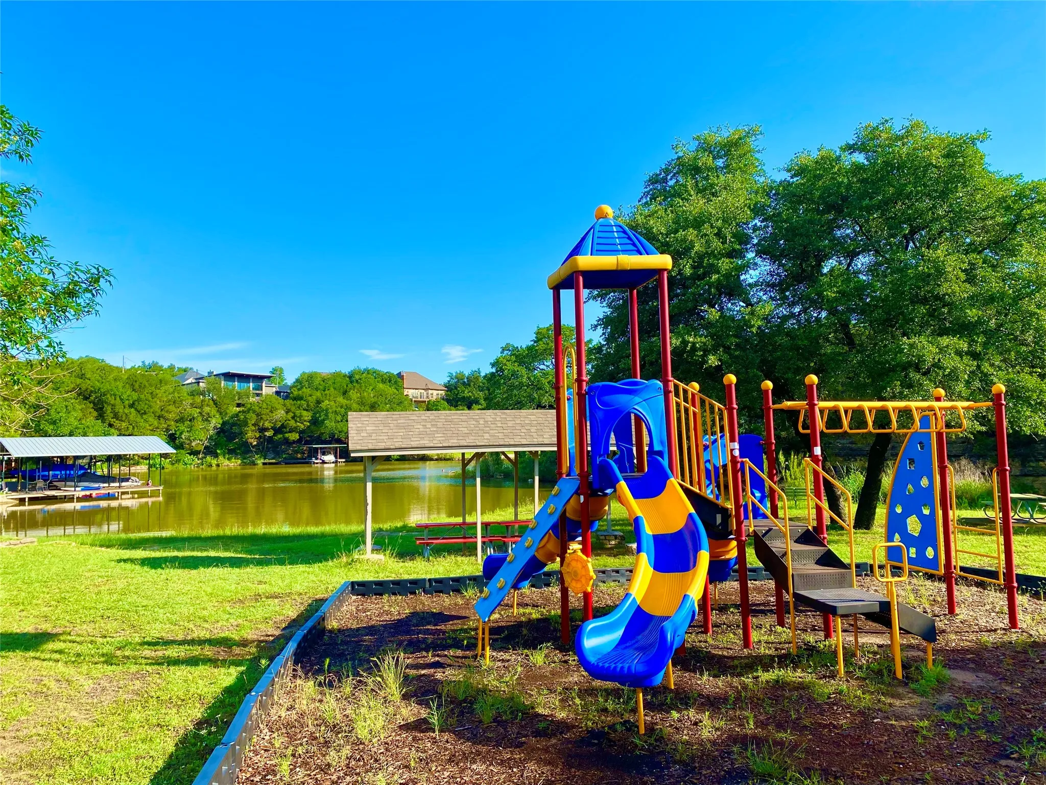 Playground near the lake with park benches and tables