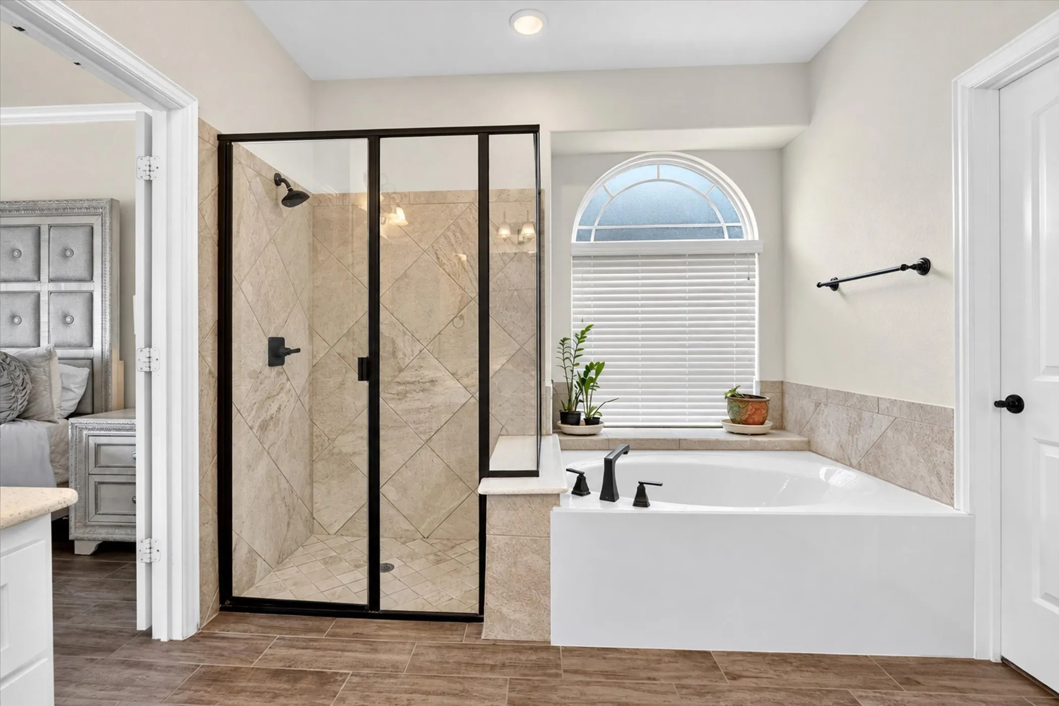 Walk-in shower with clear glass enclosure and tiled walls