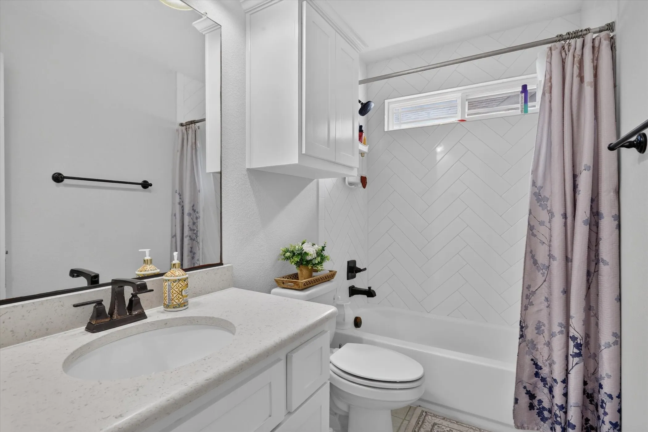 White vanity with an integrated sink and bronze-finish faucet