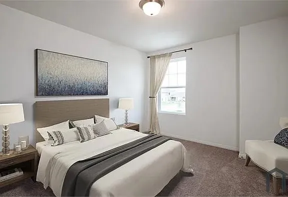 Neutral wall paint throughout, featuring a single window with a privacy drape, and a ceiling-mounted light fixture