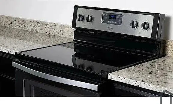 Black electric range with digital controls, stainless steel accents, and a smooth cooktop