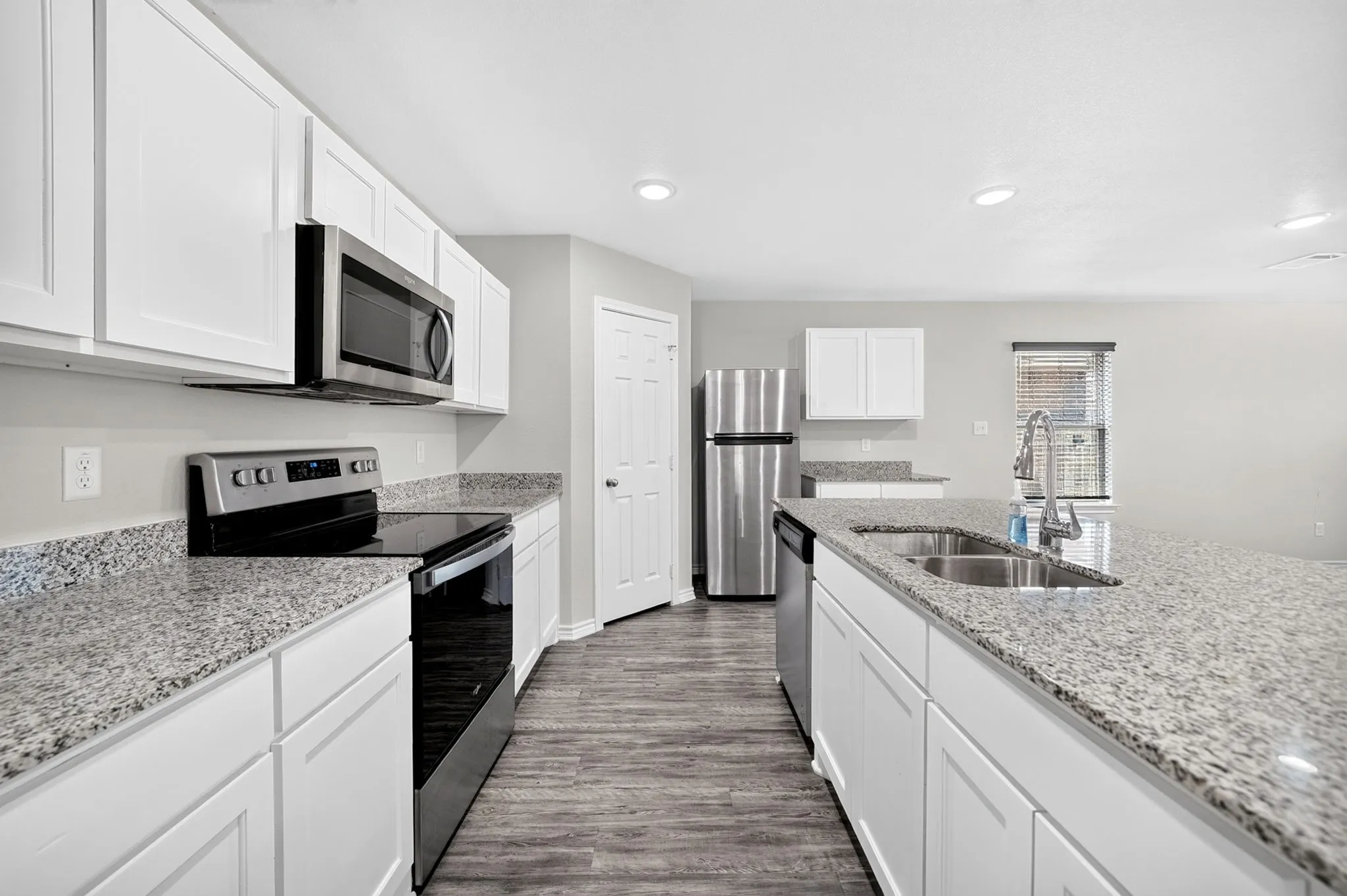 White shaker-style cabinetry with stone-look countertops