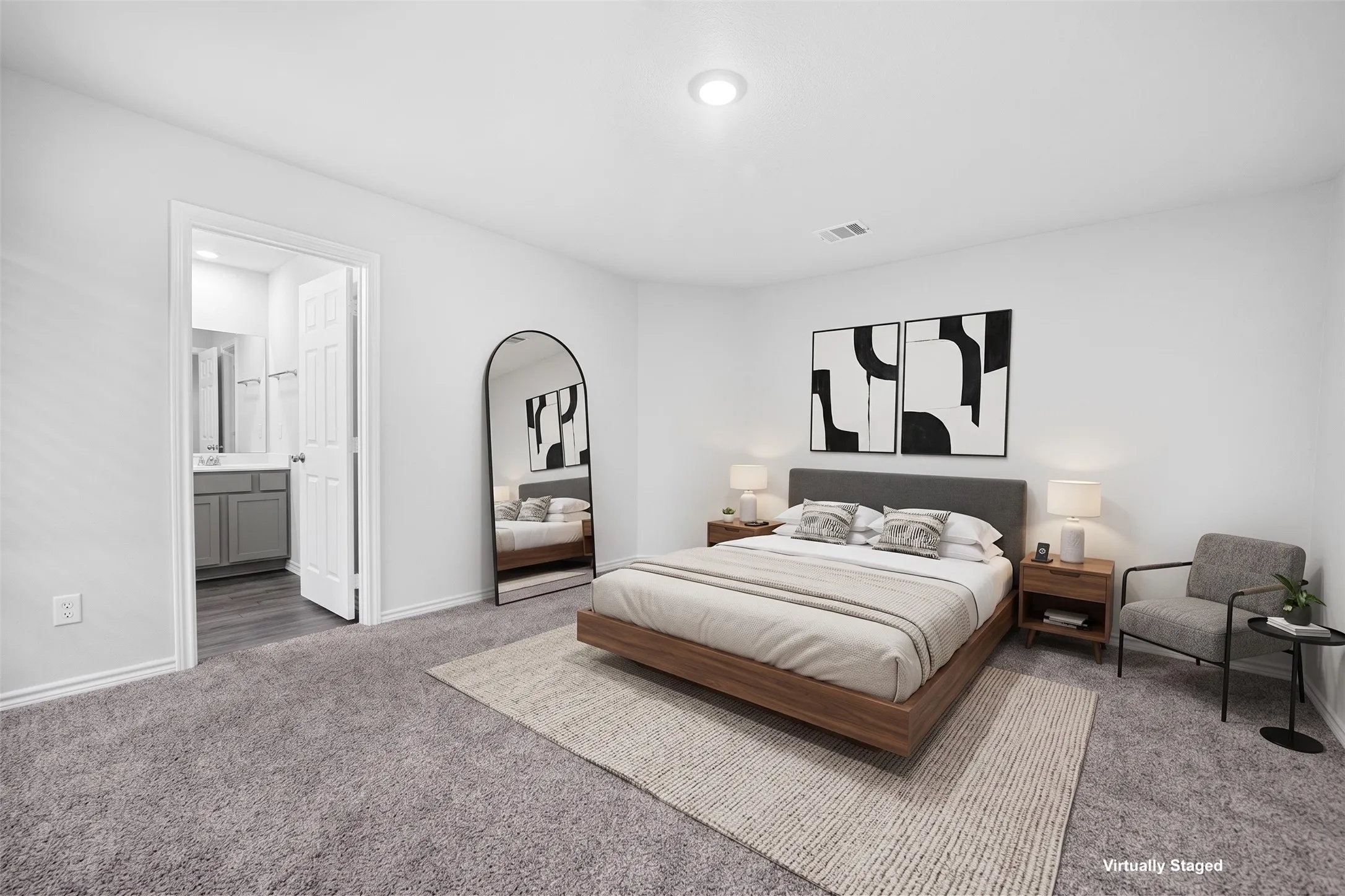 Plush grey carpeting, recessed ceiling lighting, and a neutral wall palette