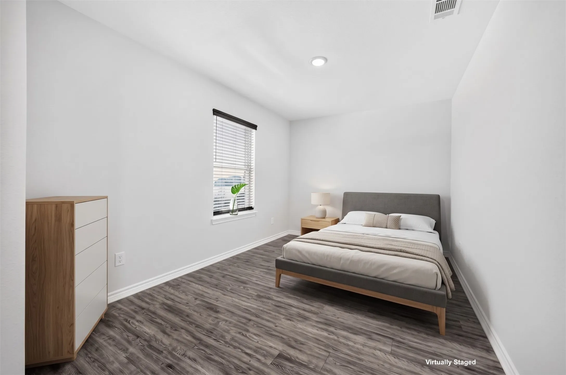 Recessed ceiling lighting, wood-finish flooring, and a window with blinds