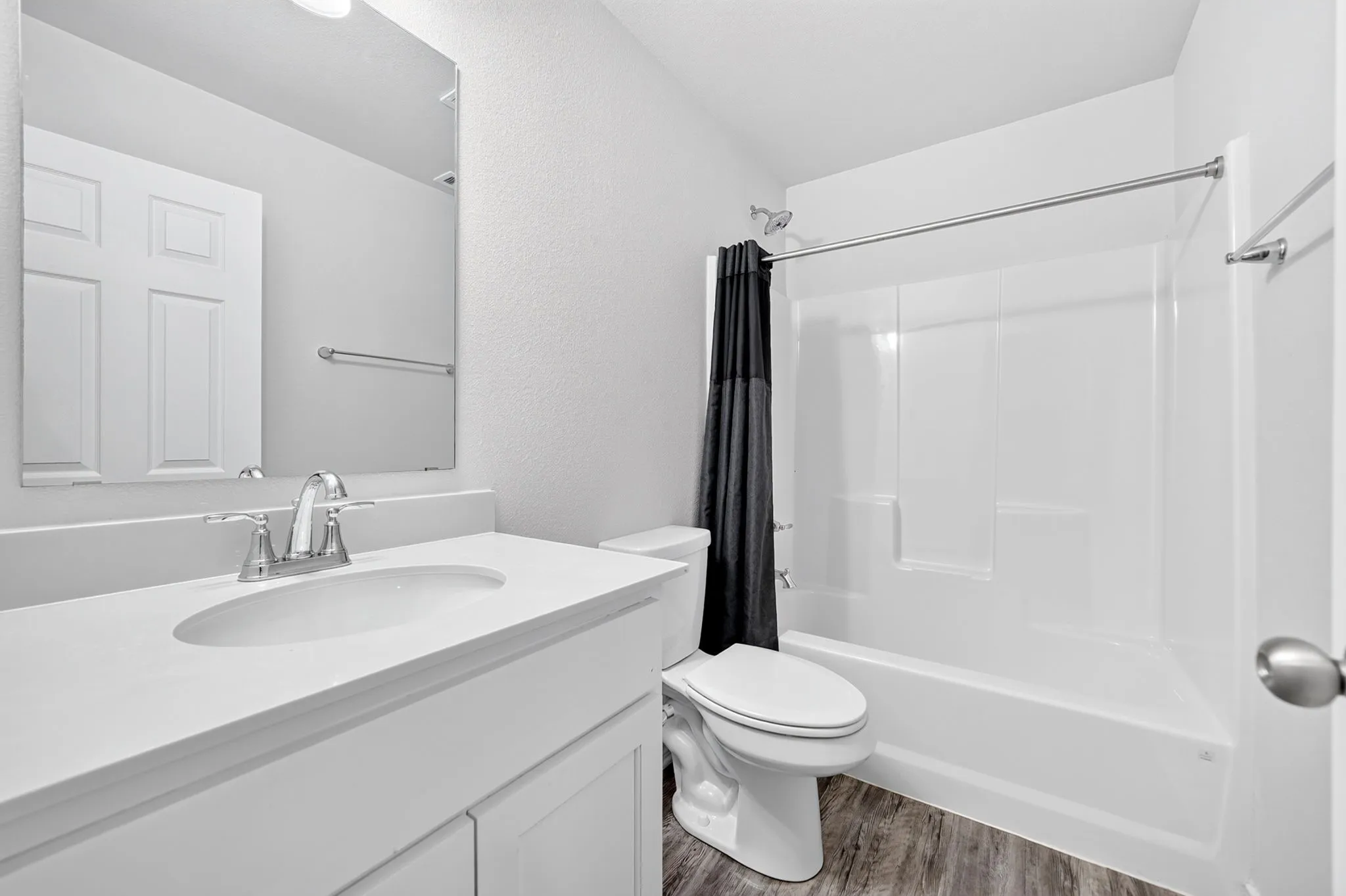 Single vanity with integrated sink, chrome faucet, and white cabinetry