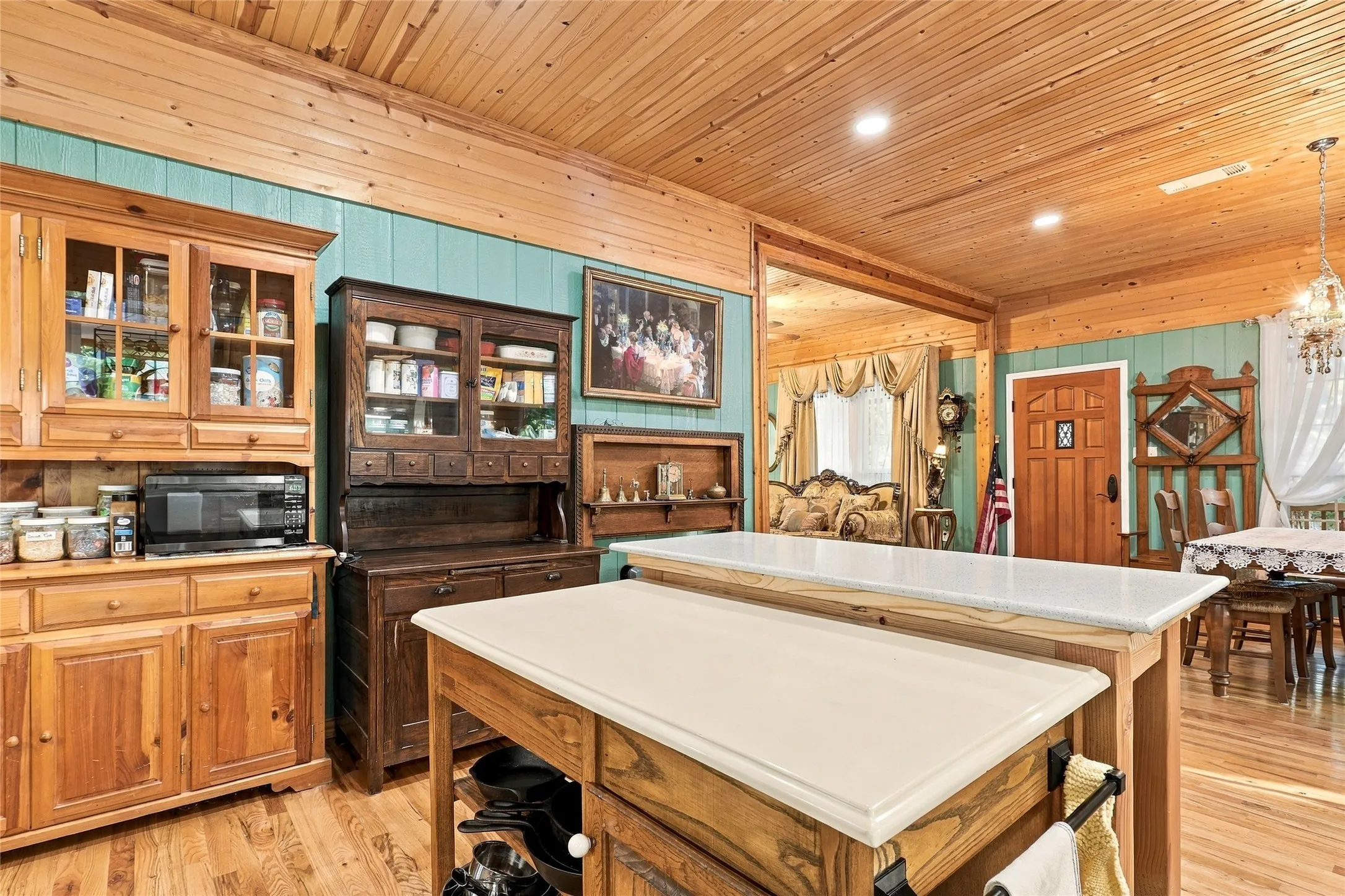 Wood-finish flooring, wood plank ceiling, and teal wall panels