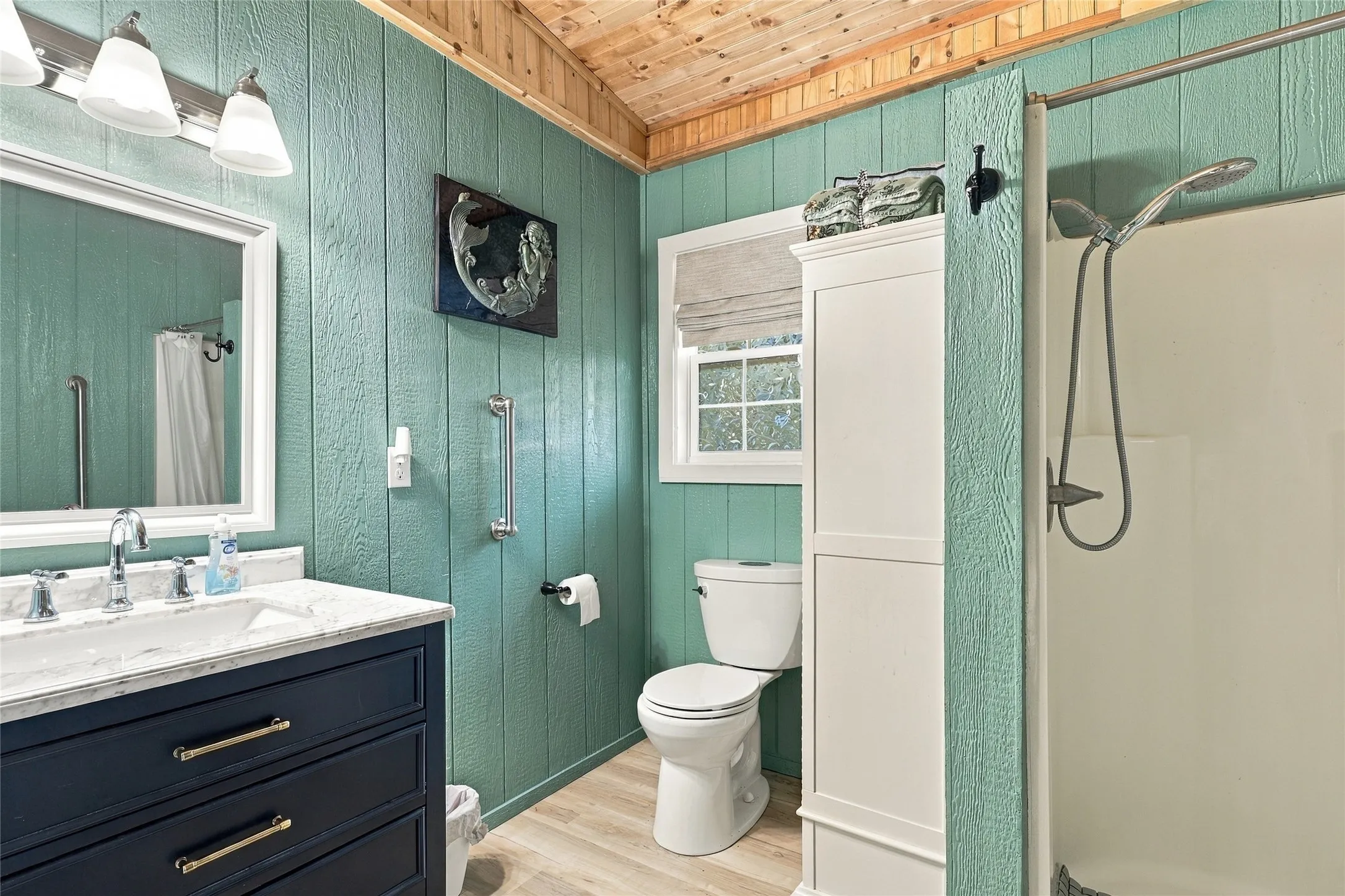 Guest Cottage Bathroom featuring a wood plank ceiling, plank wall paneling, a vanity with a white countertop, and a shower with a handheld fixture
