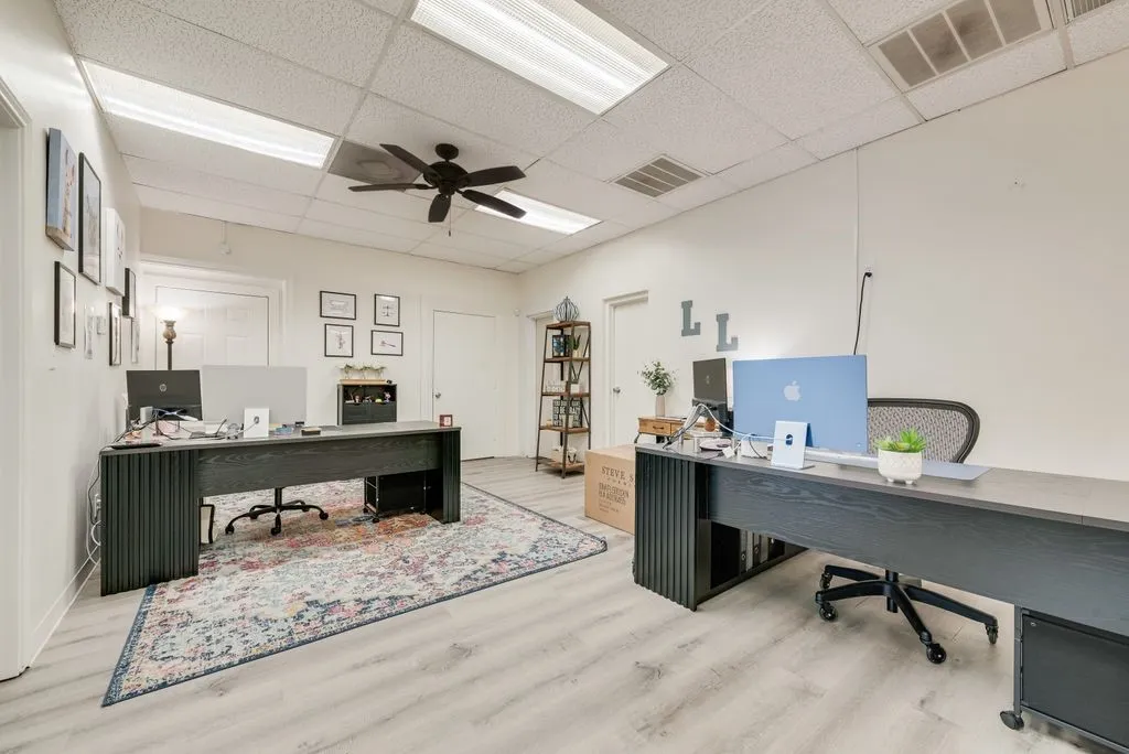 Recessed fluorescent lighting, ceiling fan, wood-finish flooring, white walls, and white doors