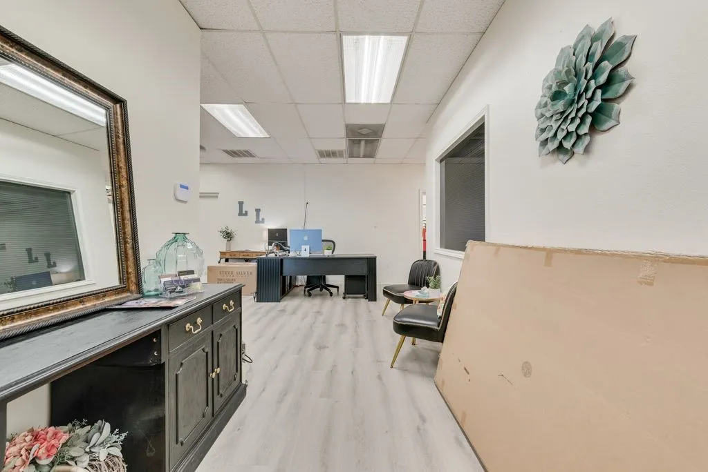 Recessed fluorescent lighting, drop ceiling, and wood-finish flooring