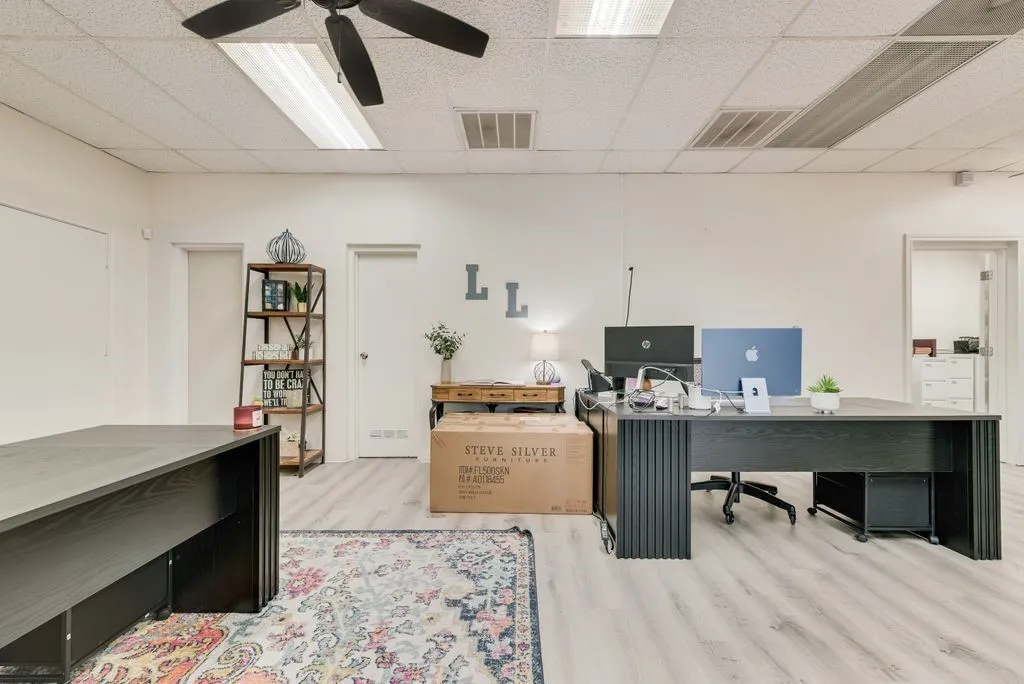Light wood-finish flooring, white walls, and recessed lighting fixtures