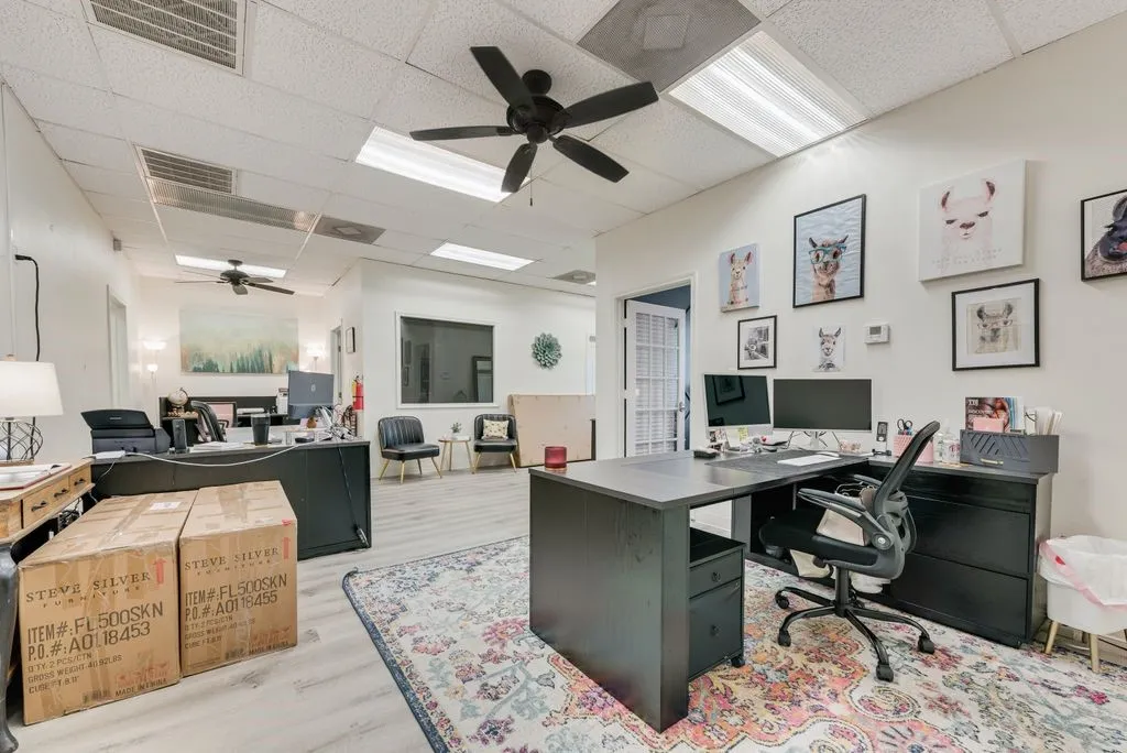 Recessed lighting and ceiling fans illuminate a spacious interior with light wood-finish flooring