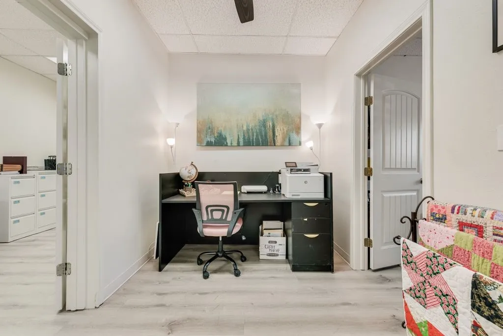 Recessed lighting, wood-finish flooring, white walls, and bright overhead lighting