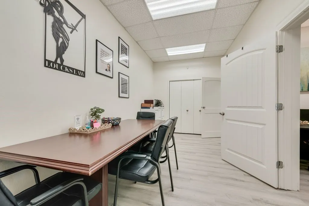 Recessed panel doors, light wood-finish flooring, drop ceiling with integrated lighting, and bi-fold closet doors