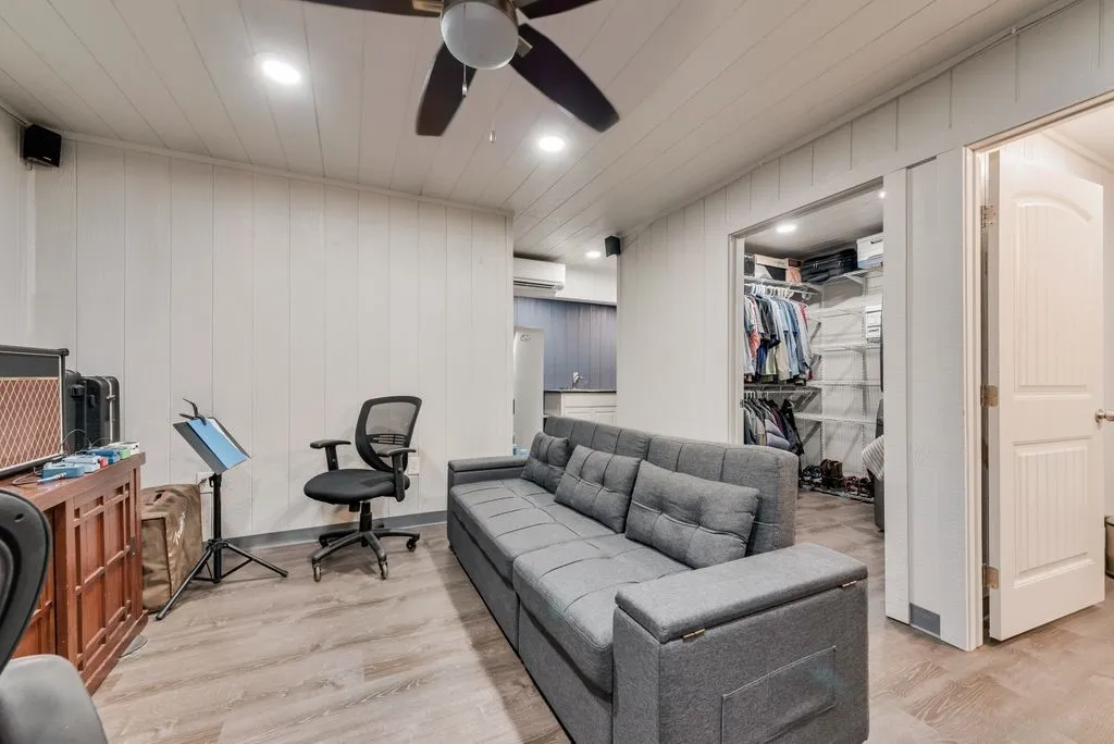 Wood-finish flooring, recessed lighting, ceiling fan, and a built-in closet system
