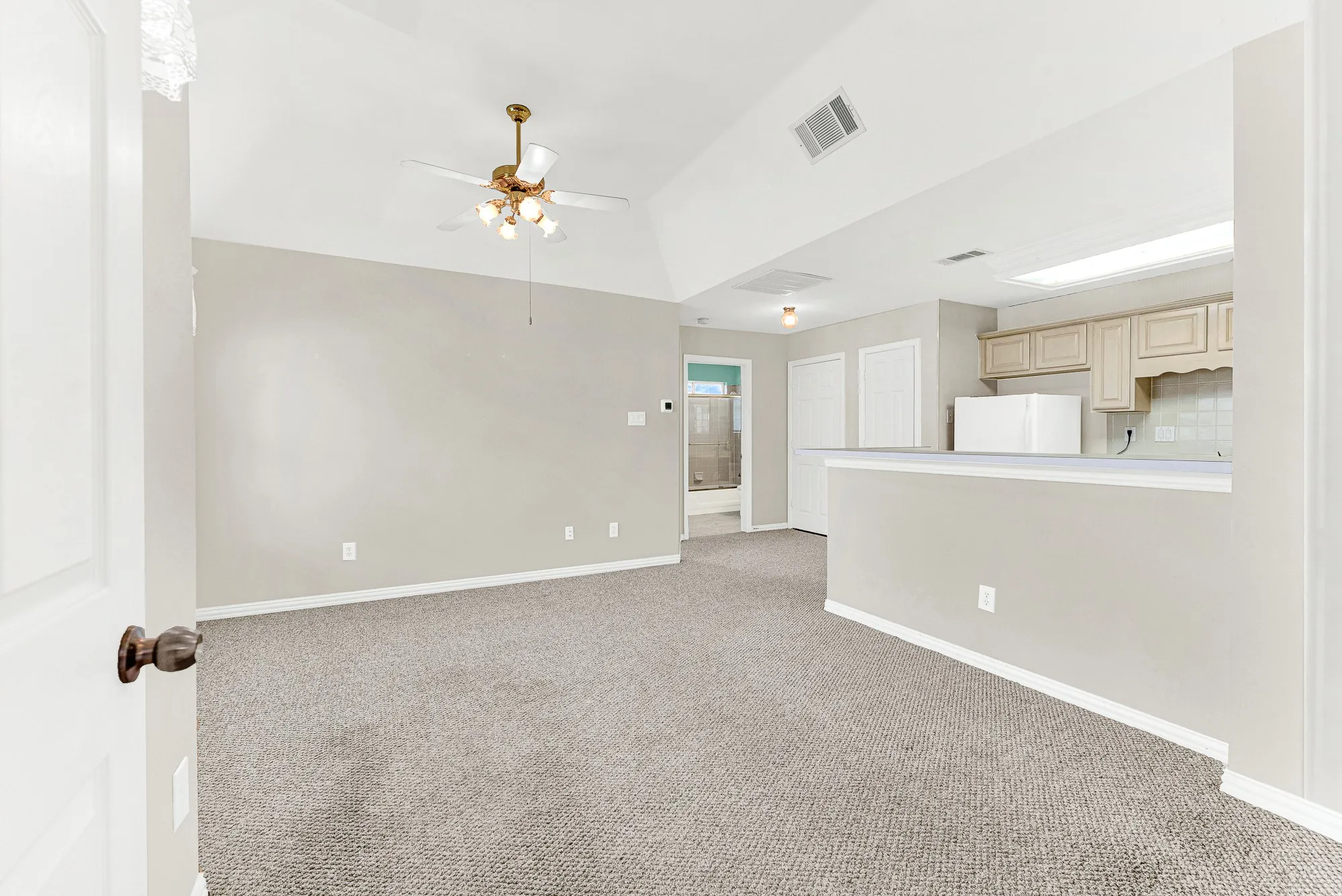 A vaulted ceiling and ceiling fan air out this spacious open living area set directly off the upstairs game room. It offers multi-generational guests or extended family their own complete, private living space upstairs
