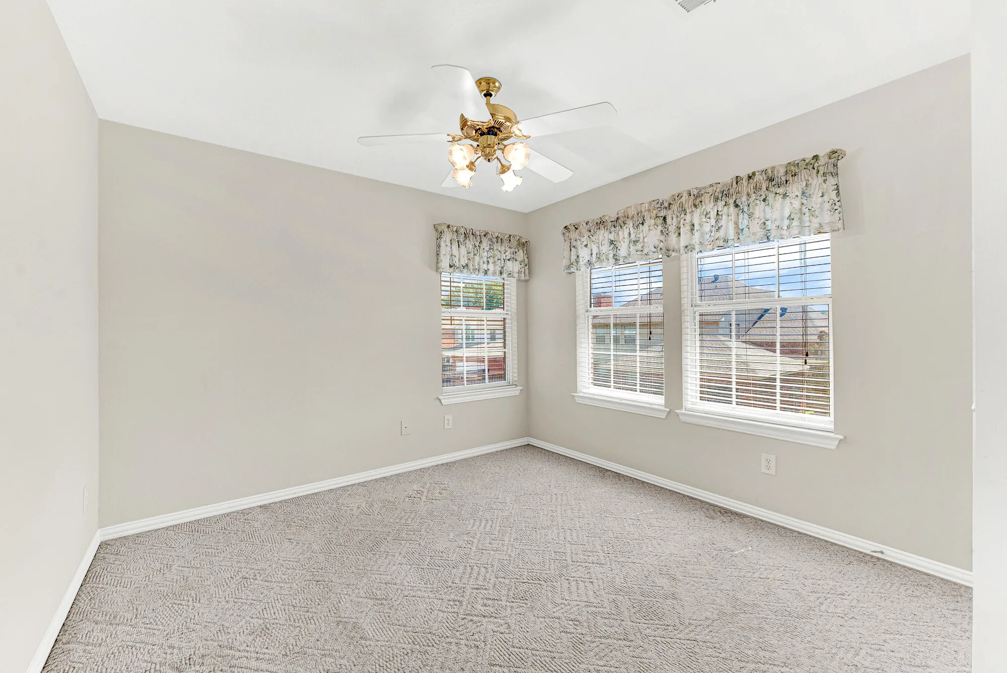 Plush carpeting and dual sunlit windows define this quiet private bedroom sanctuary. A cozy space to unwind, read, or catch a restful night's sleep