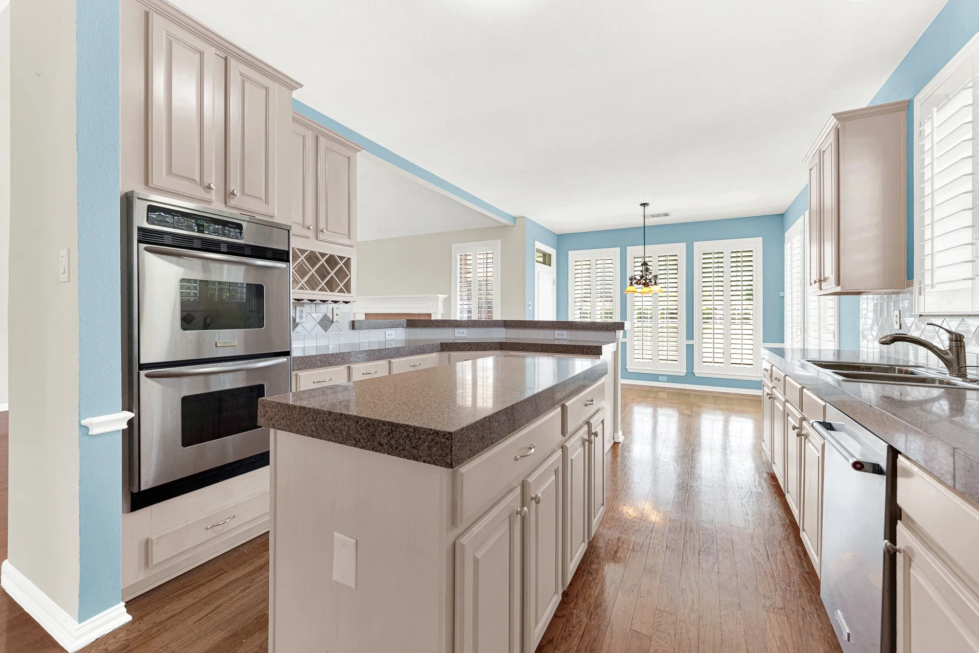 An open peninsula overlooks the sunny breakfast nook, maintaining a bright flow into adjacent dining spaces. Start your morning grabbing quick bites here before the day gets busy