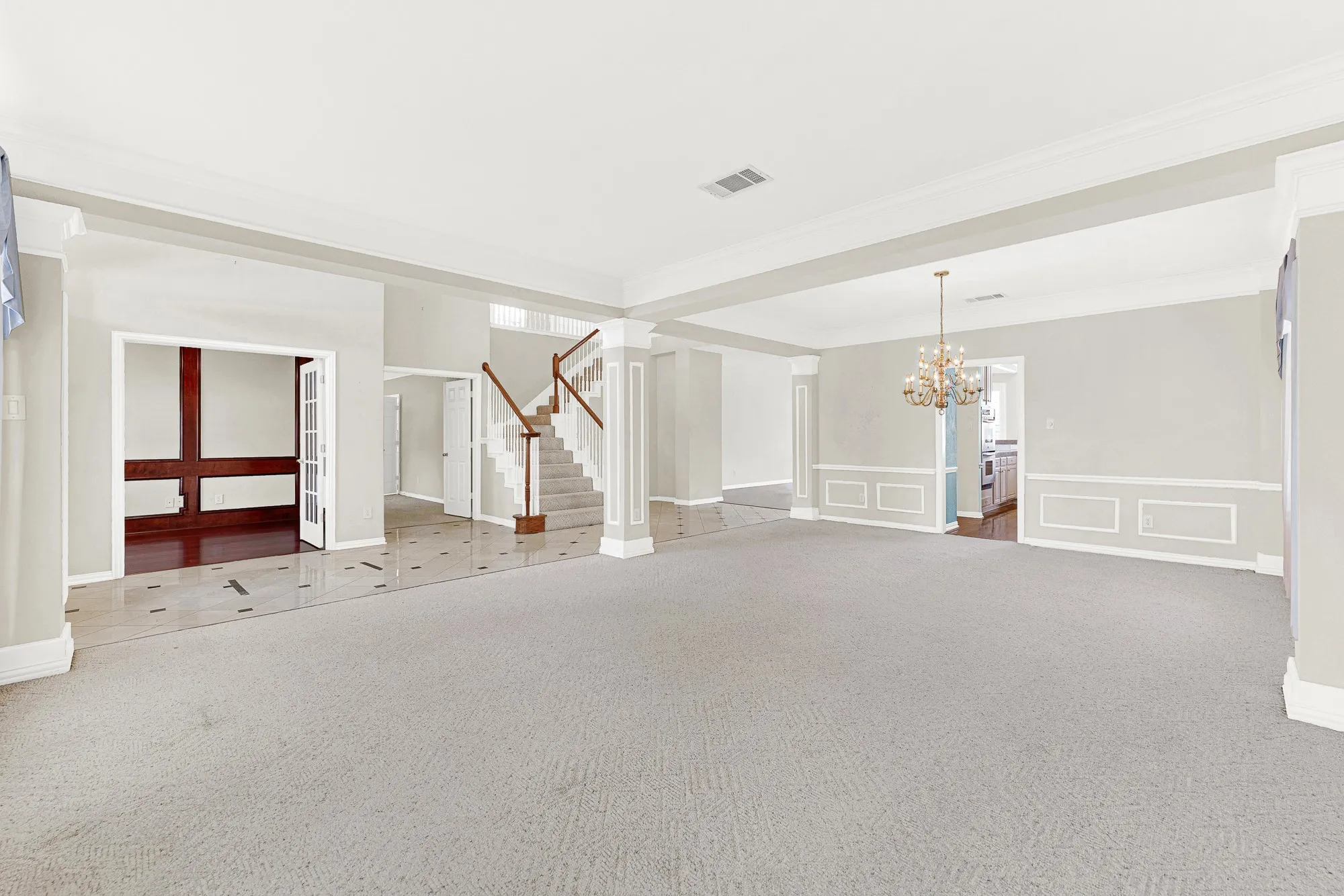 FABULOUS REMODEL OPPURTUNITY!!! Classic wainscoting and defined support columns create a sense of structure while keeping the flow into adjacent spaces completely effortless. Imagine gathering here with family after dinner for lively games and conversation