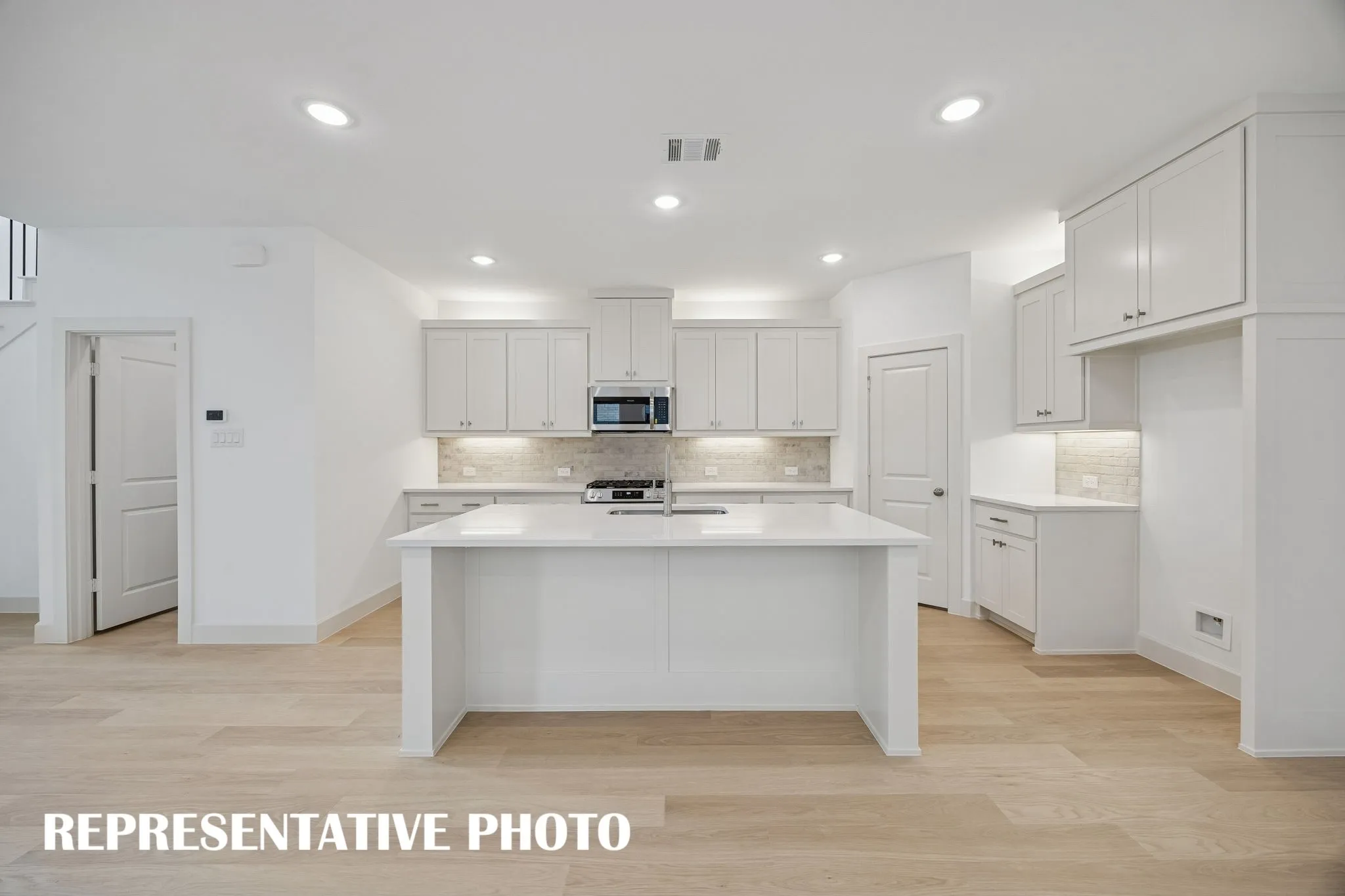 The large kitchen island is the hub of your new dream kitchen!  REPRESENTATIVE PHOTO