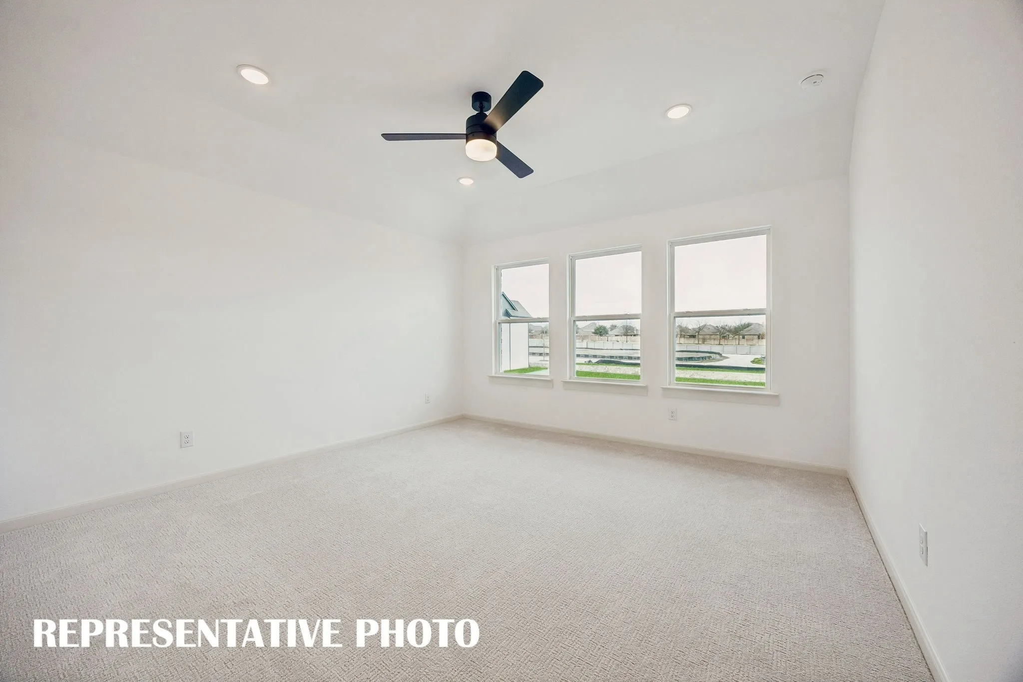 High ceilings, plush carpeting, a wall of windows and luxurious en suite bath create an owner's suite that you will never want to leave!  REPRESENTATIVE PHOTO