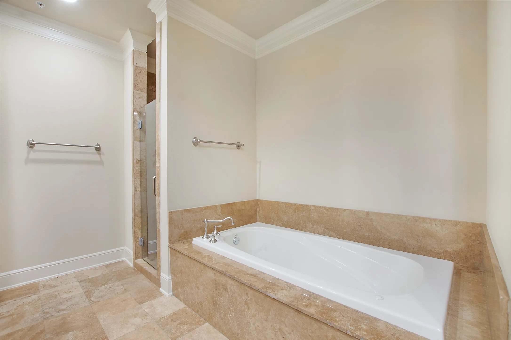 Bathroom featuring ornamental molding and independent shower and bath
